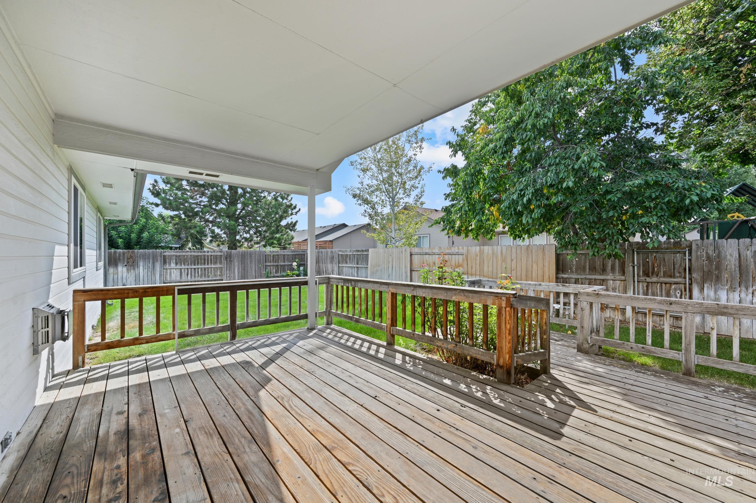 Deck with a fenced backyard
