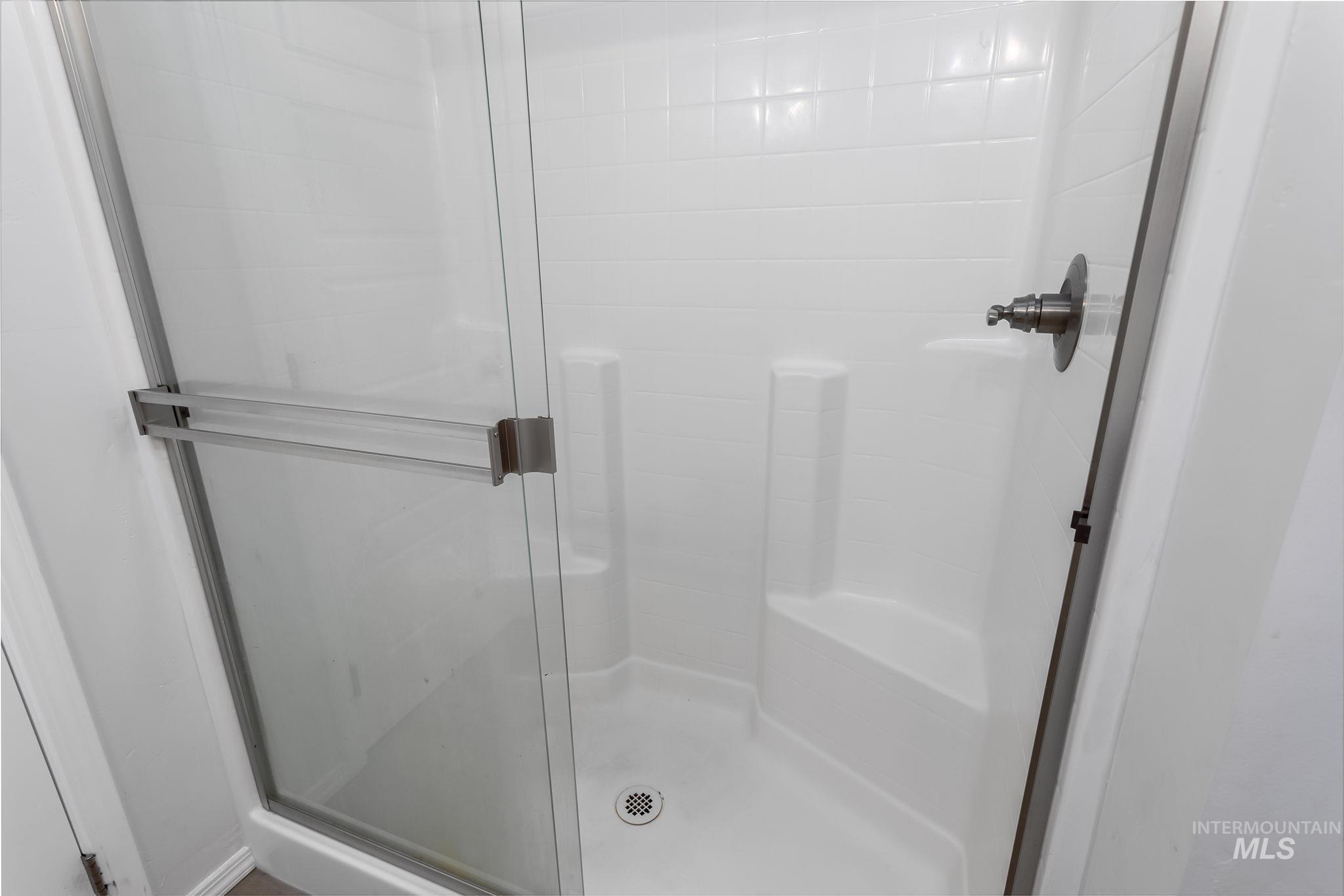 Full bath with a shower stall