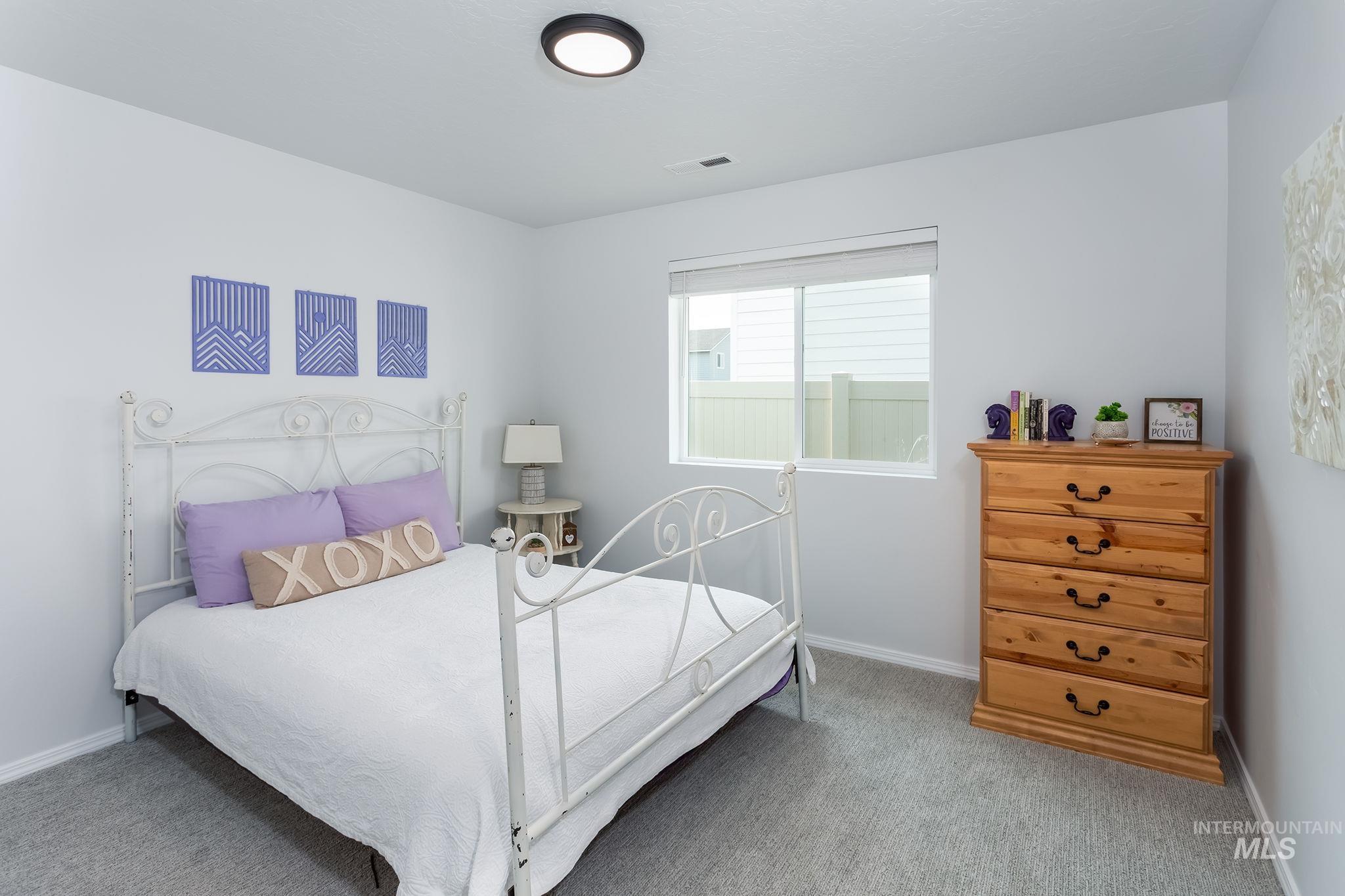 Bedroom featuring carpet flooring and baseboards