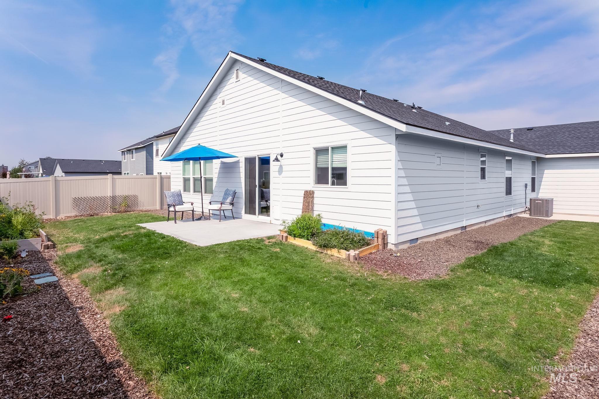 Back of property featuring a patio area, a shingled roof, and crawl space
