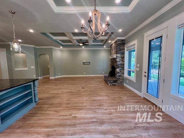Unfurnished dining area with coffered ceiling, crown molding, a chandelier, light wood-style flooring, and recessed lighting