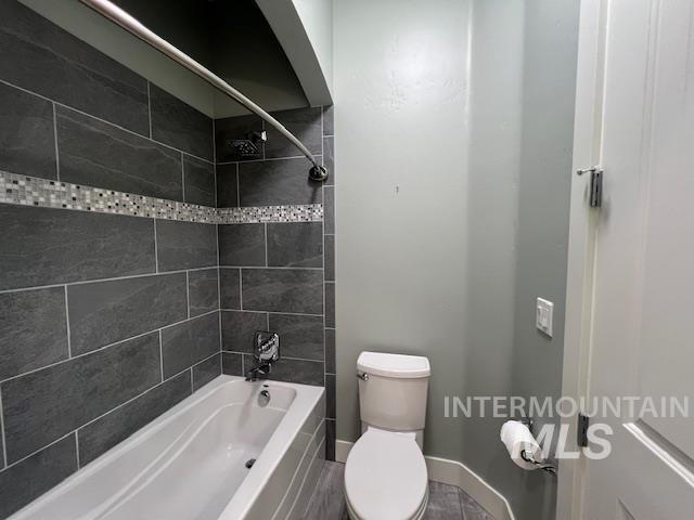 Bathroom featuring bathtub / shower combination and toilet