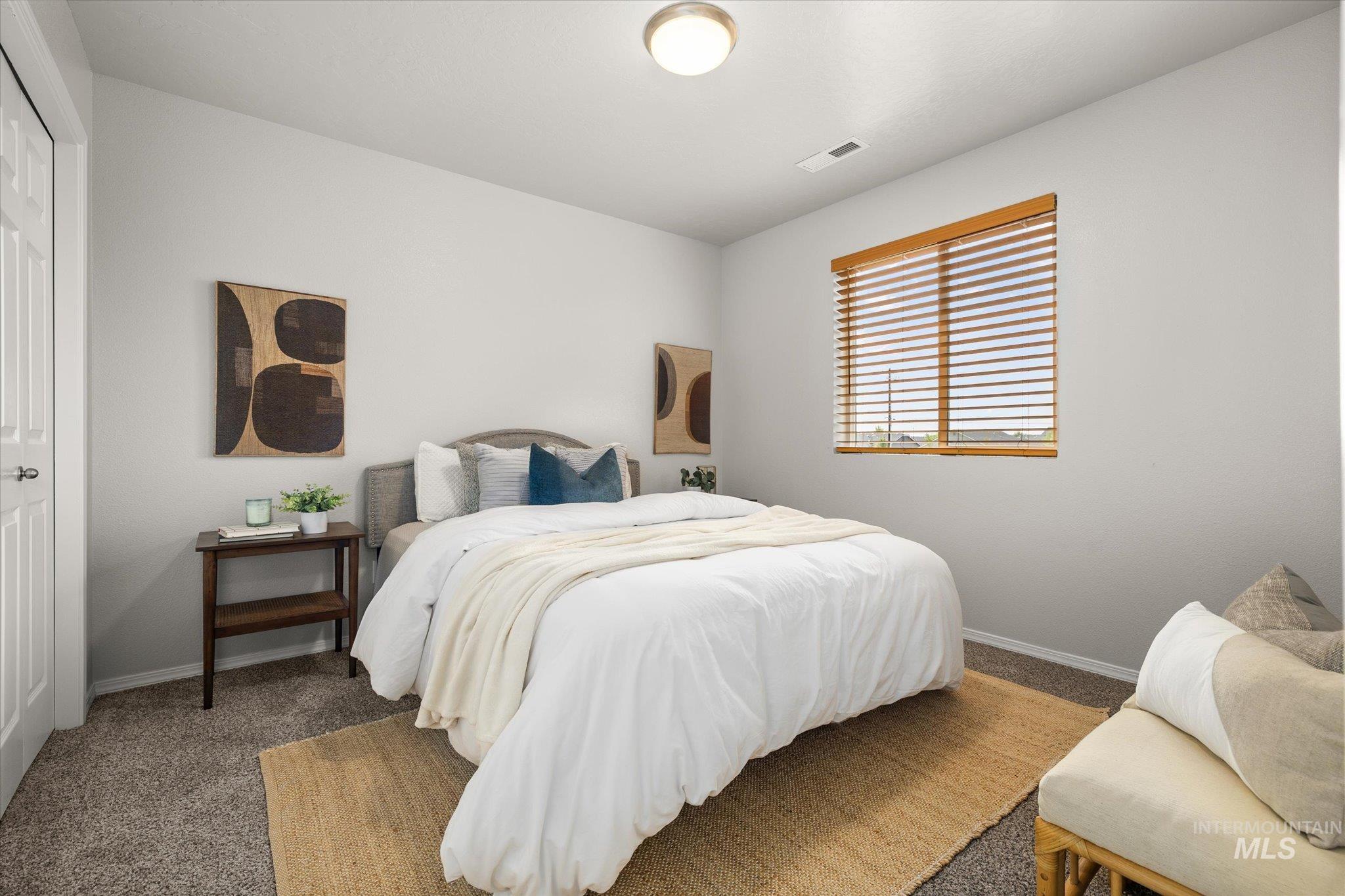 Carpeted bedroom featuring baseboards