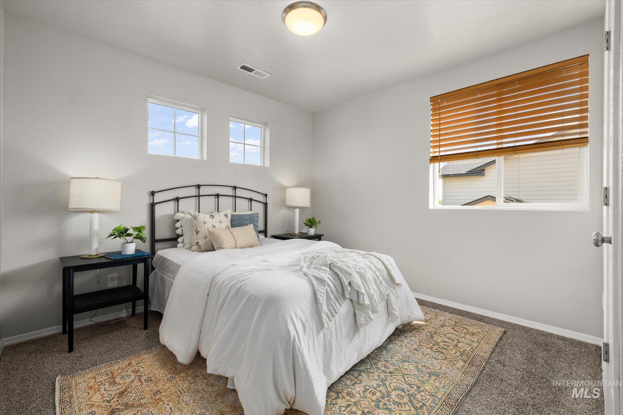 Carpeted bedroom with baseboards