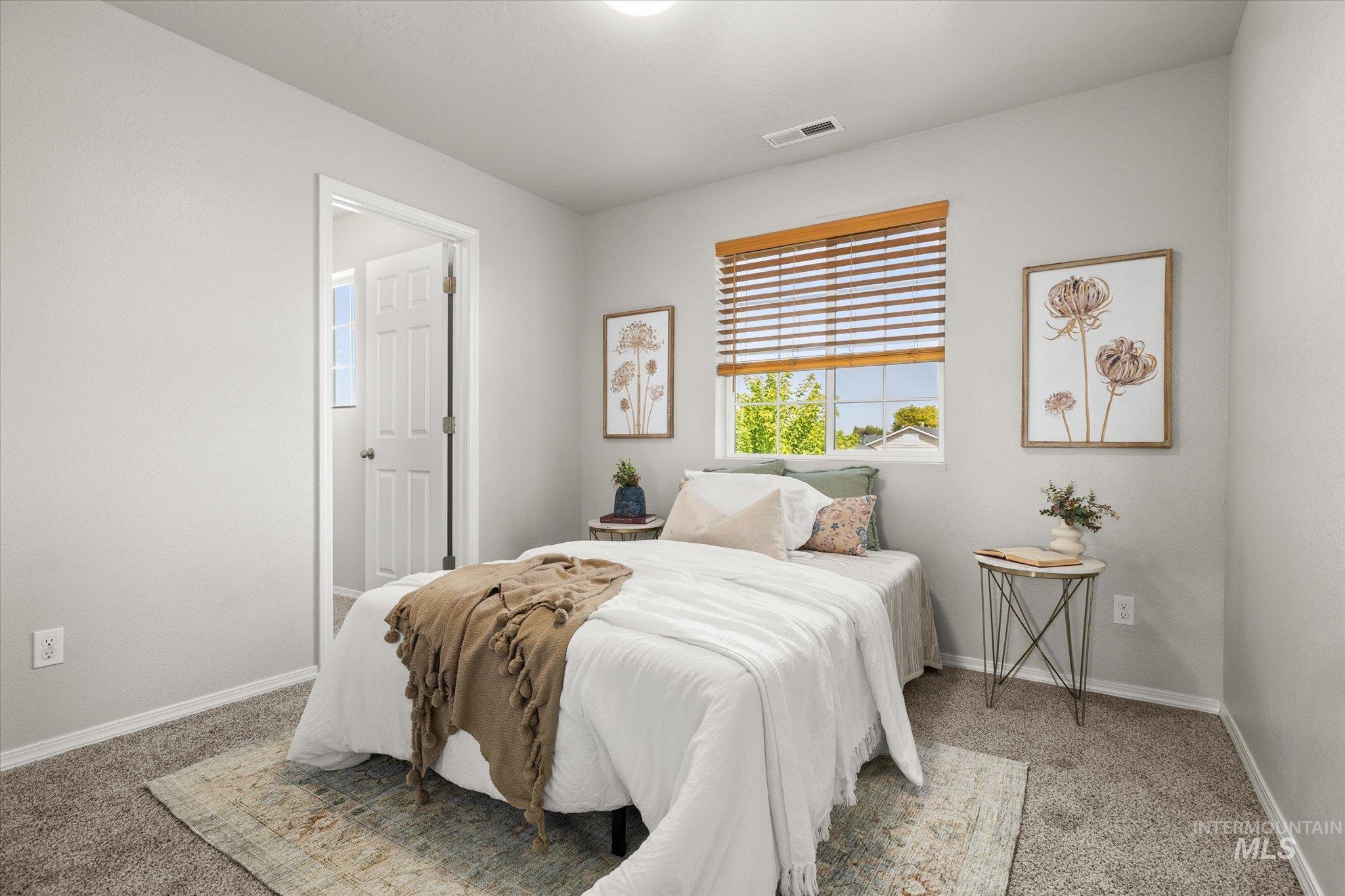Bedroom with light carpet and baseboards