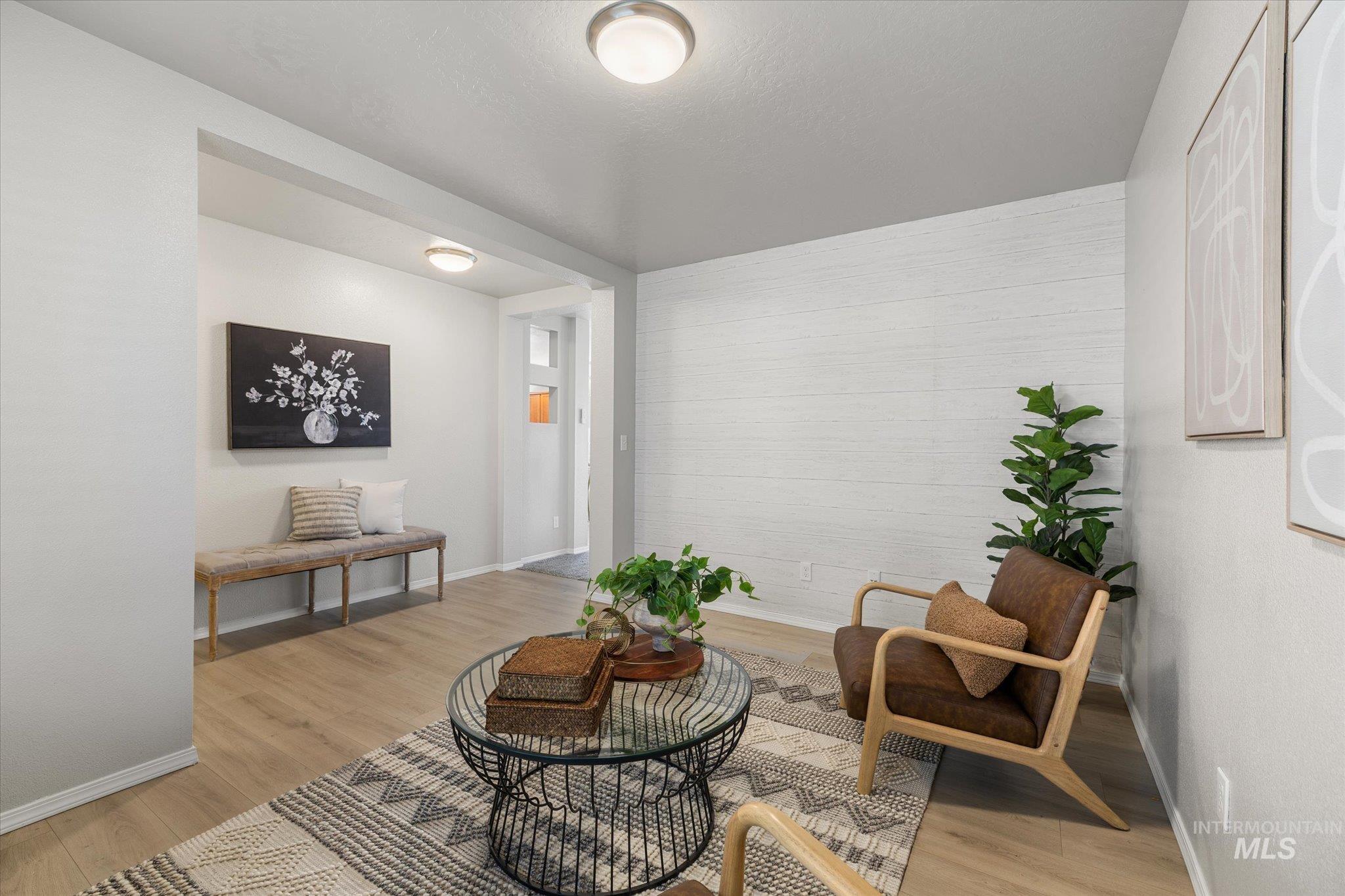 Sitting room with baseboards and light wood finished floors