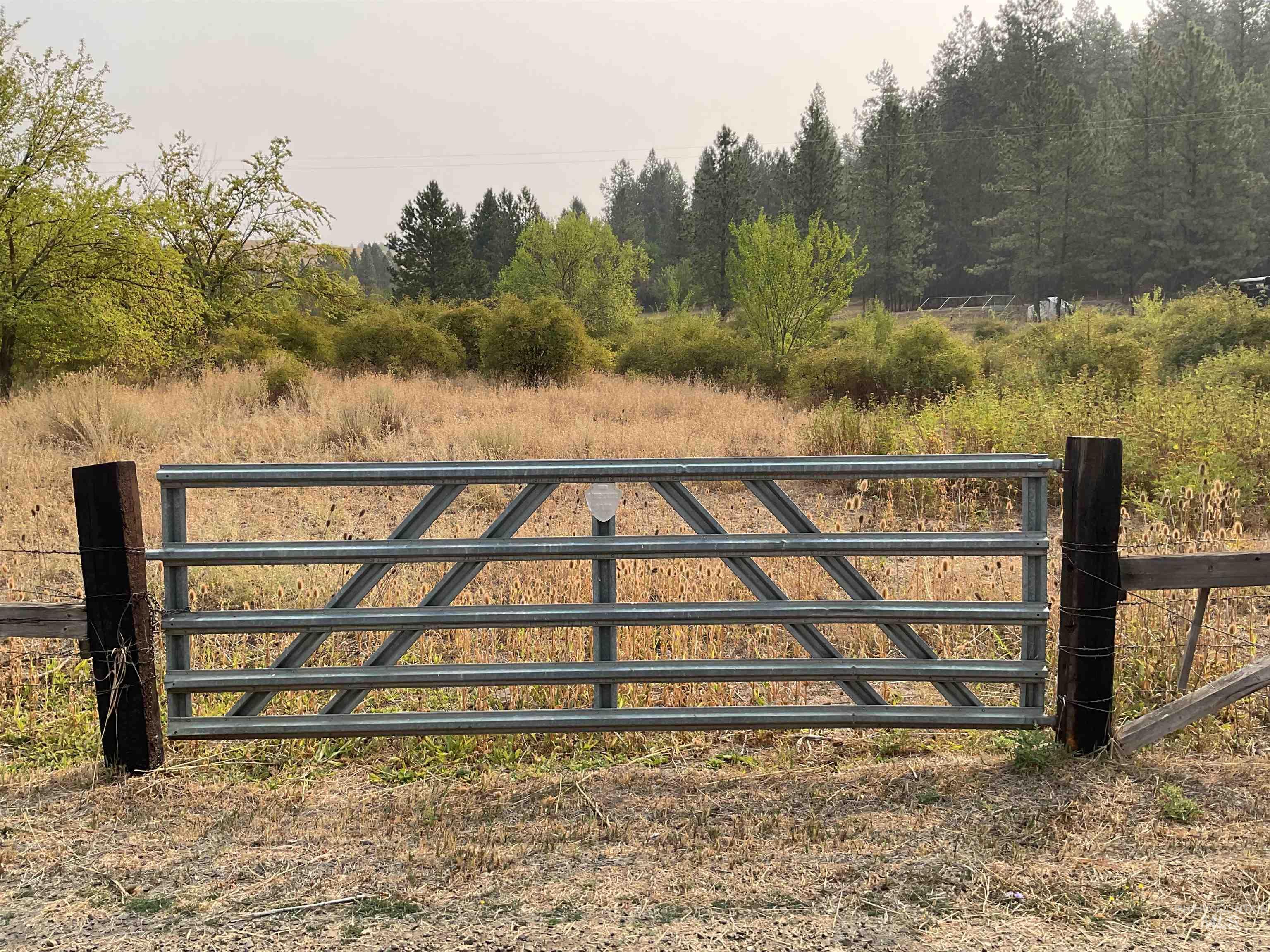 Gate with view of wooded area