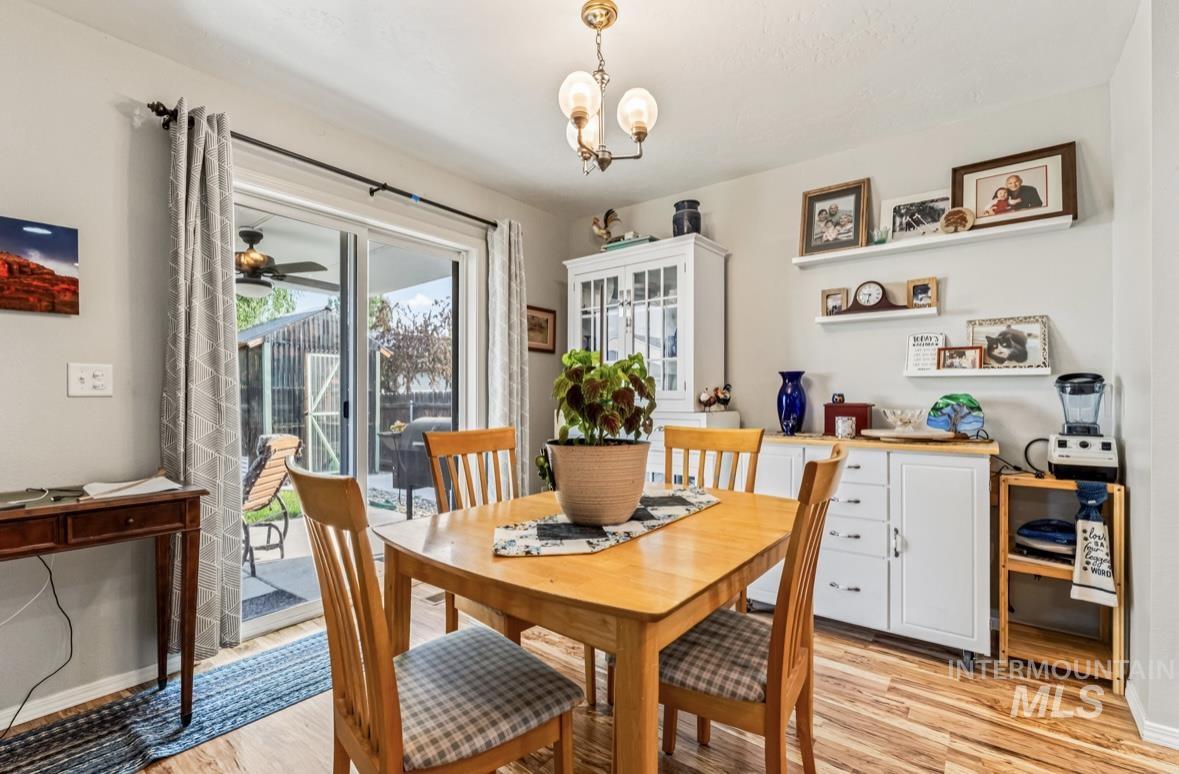 Dining room with light wood finished floors and a chandelier