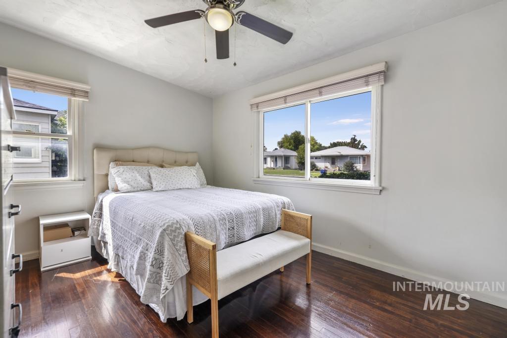 Bedroom featuring dark wood finished floors and a ceiling fan