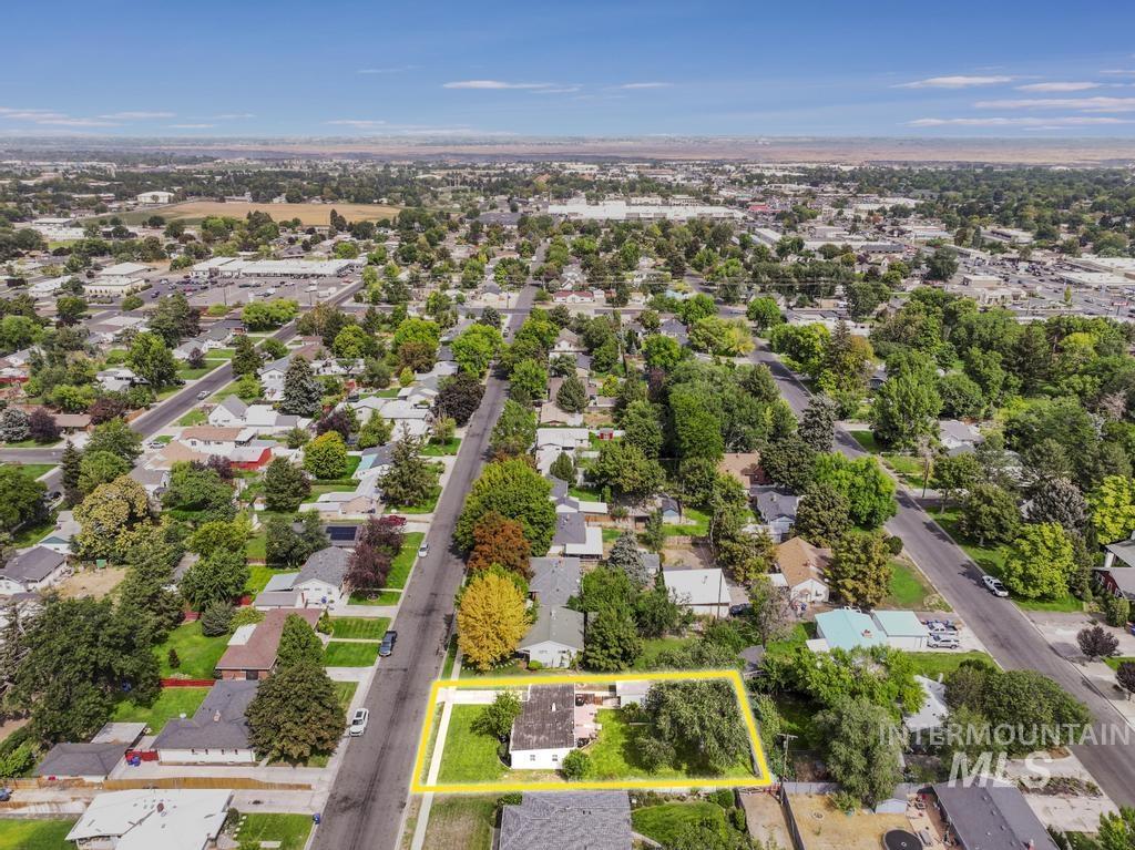 Aerial perspective of suburban area featuring property boundaries highlighted