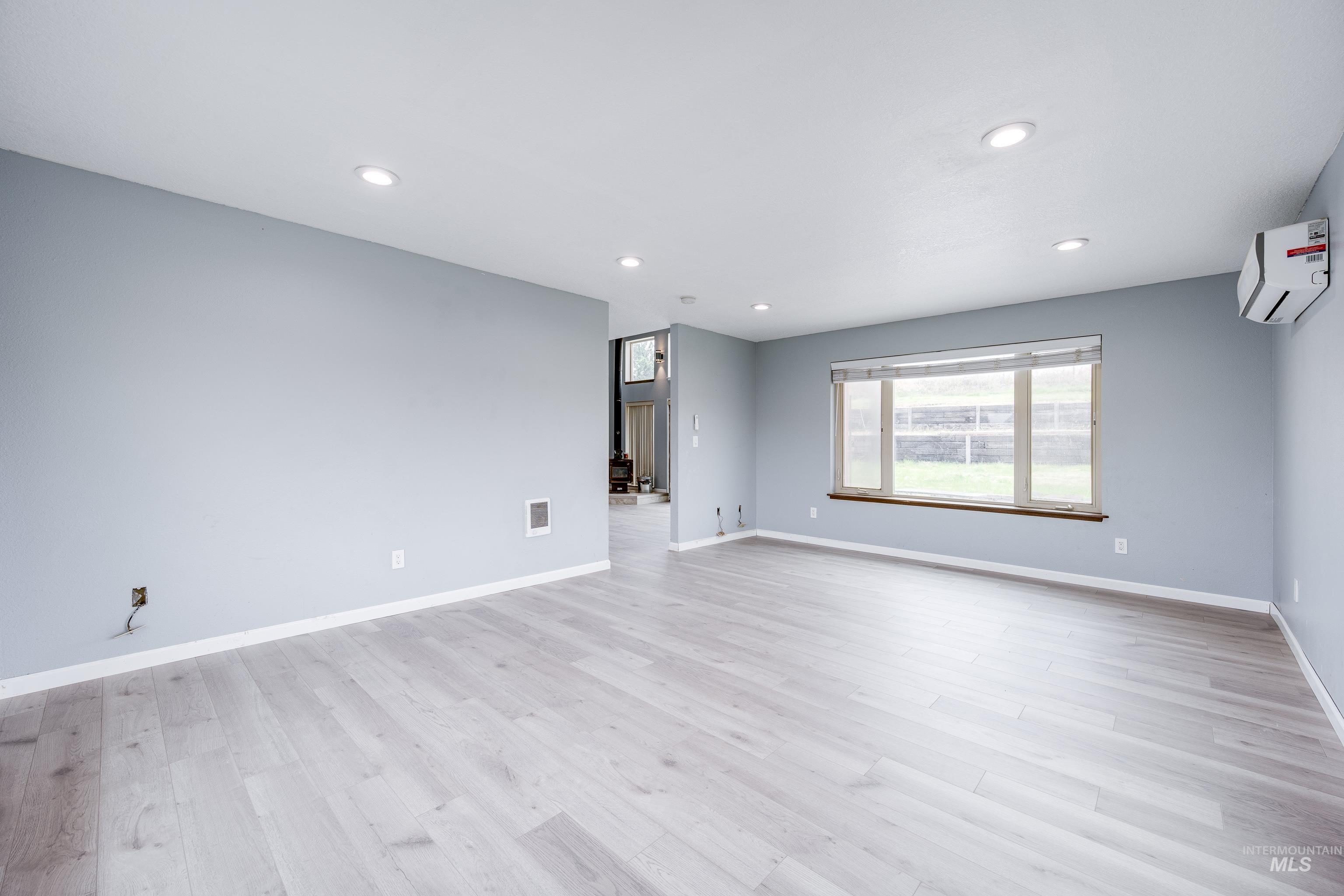 Spare room with recessed lighting and light wood-style flooring