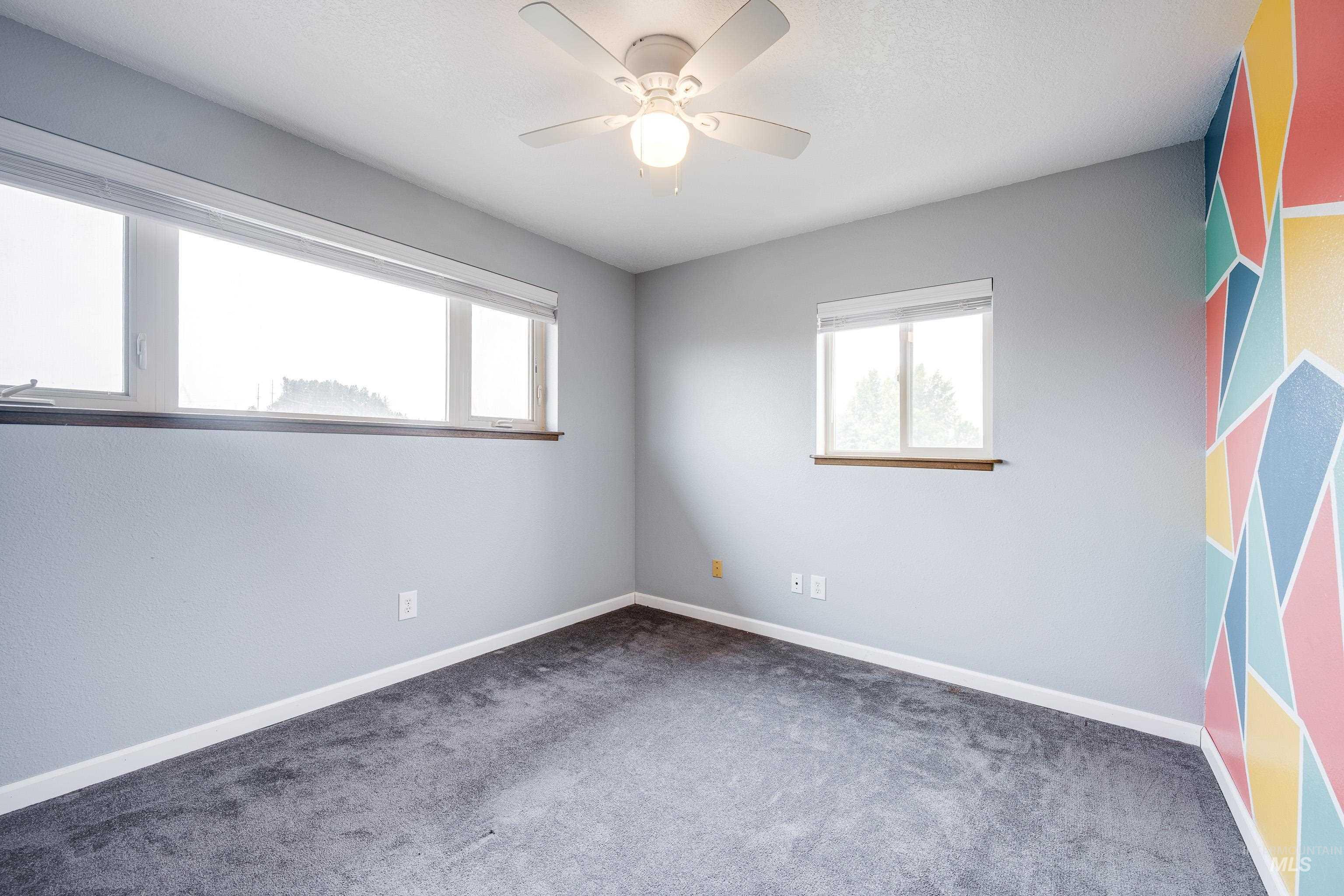 Spare room with carpet floors and ceiling fan