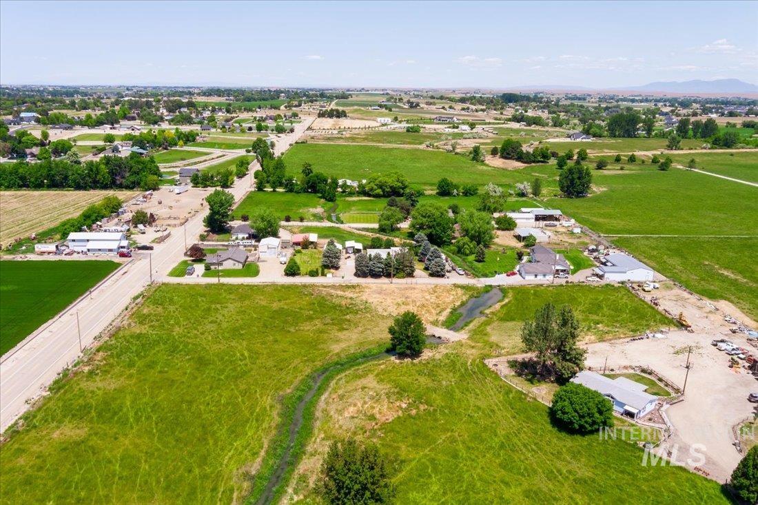 Aerial view of property's location featuring rural landscape and farmland