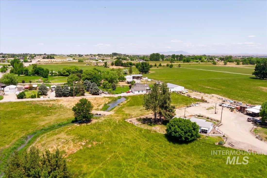Aerial view of sparsely populated area featuring abundant farmland and a mountainous background