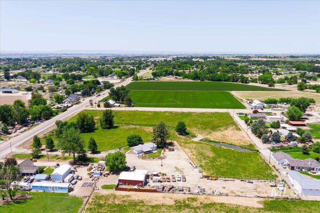 Aerial view of sparsely populated area featuring rows of crops