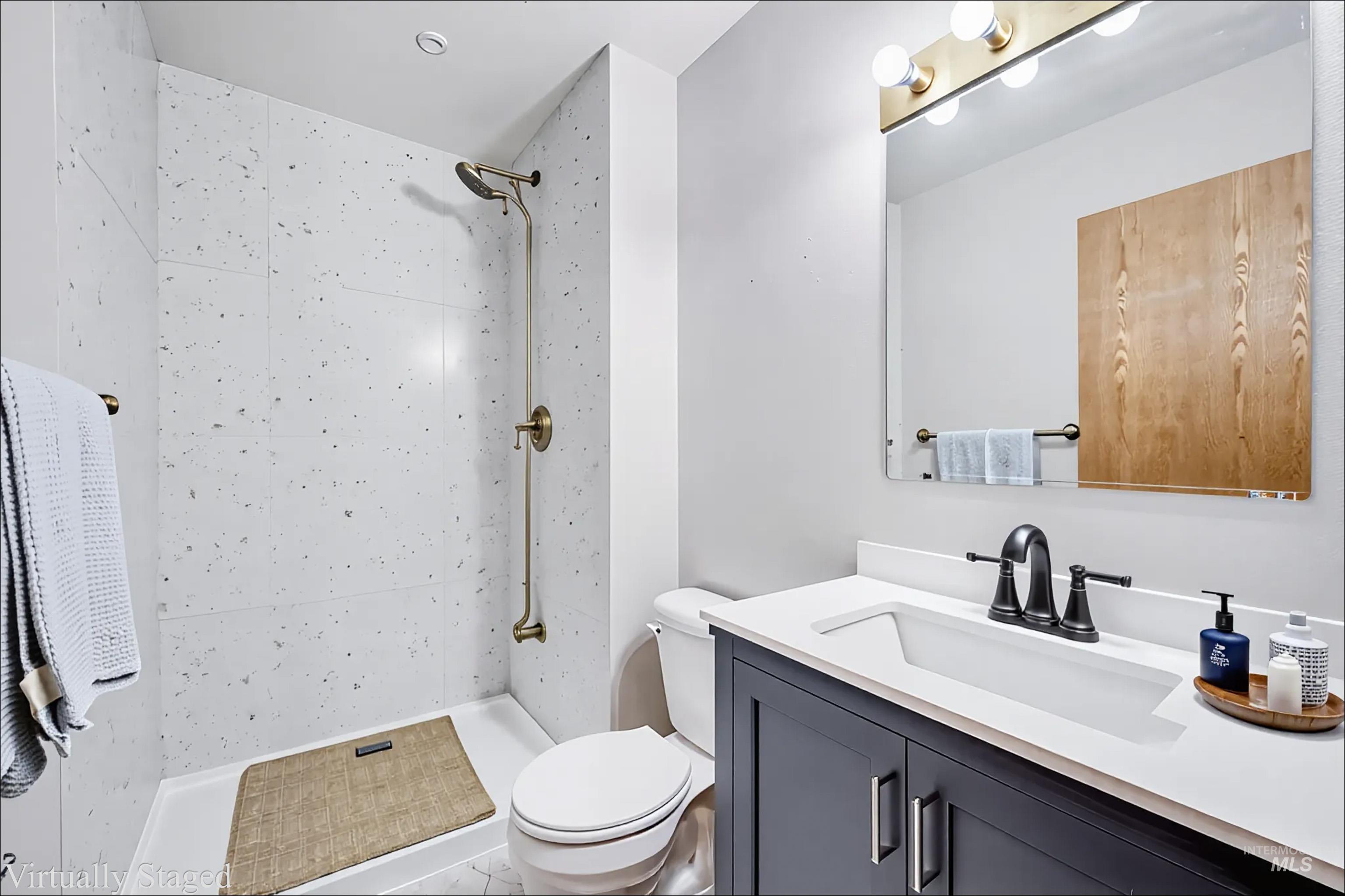 Full bath with vanity and a shower stall