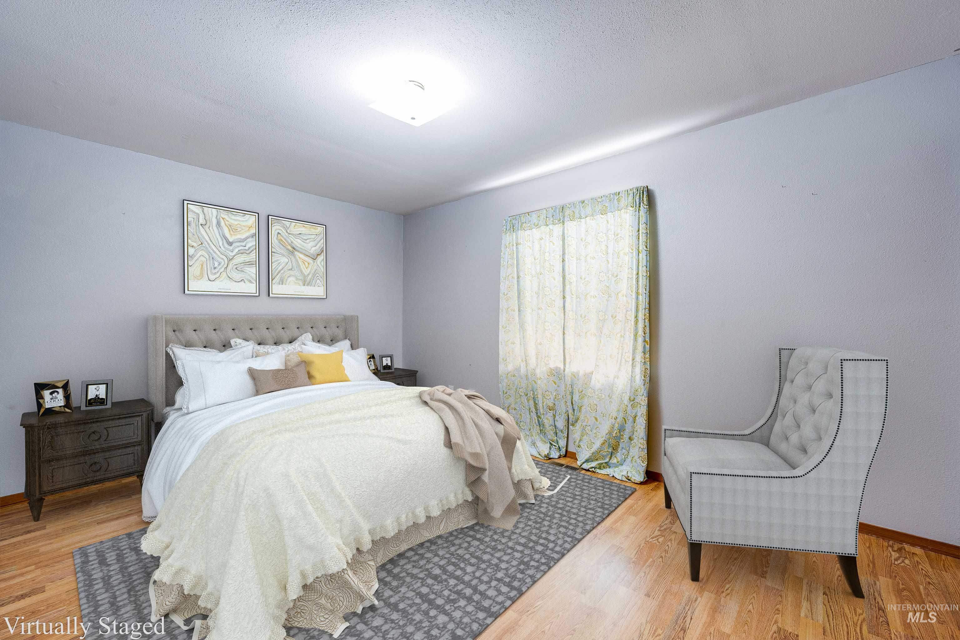 Bedroom featuring wood finished floors and a textured ceiling