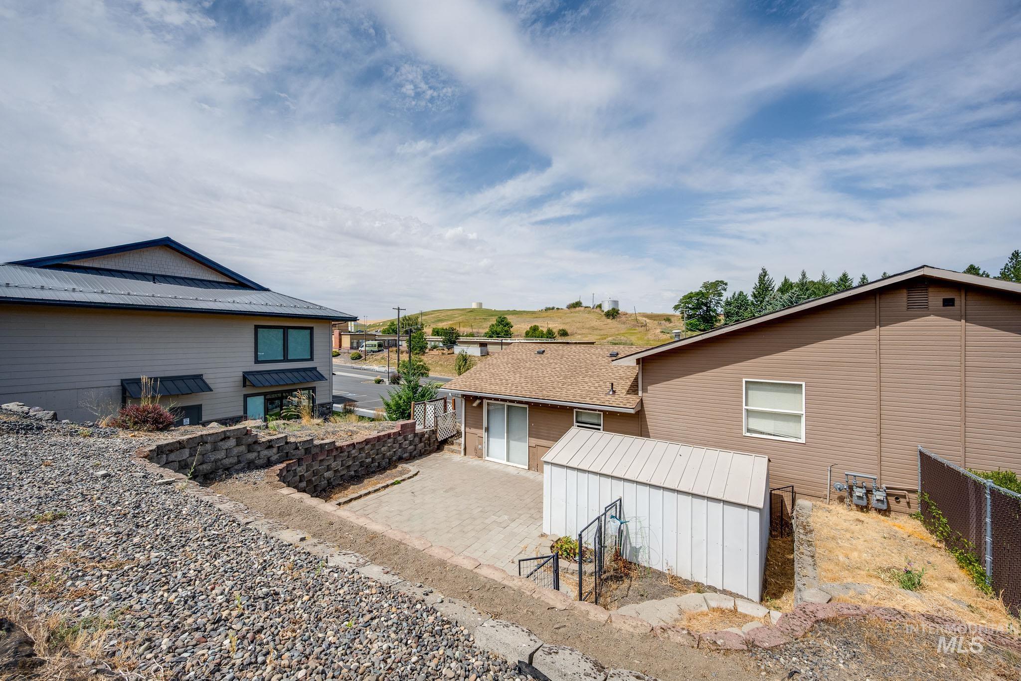 Back of property with an outdoor structure and a patio area
