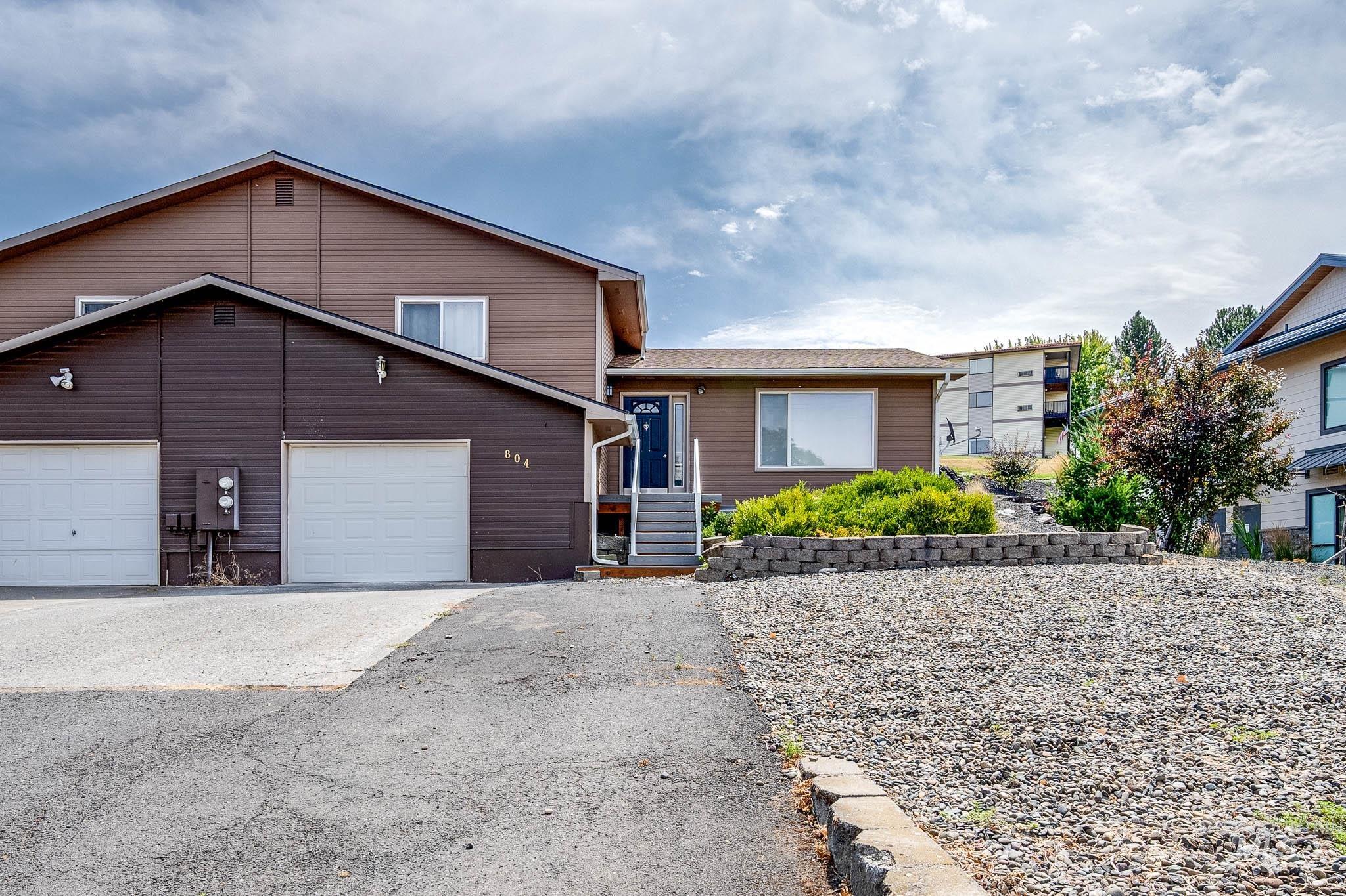 Tri-level home featuring asphalt driveway and a garage
