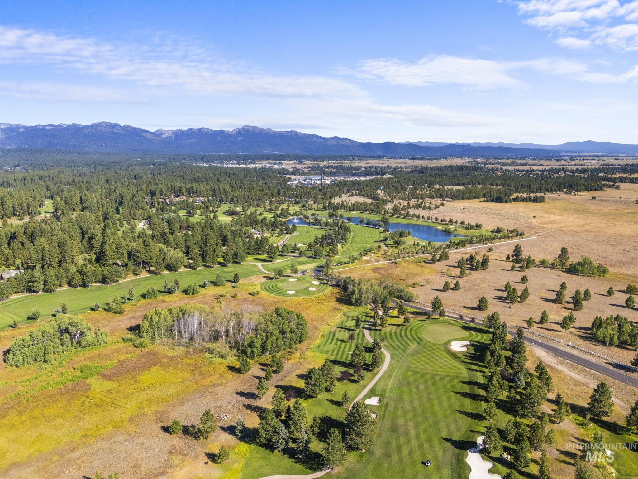 Bird's eye view of a water and mountain view and a golf course