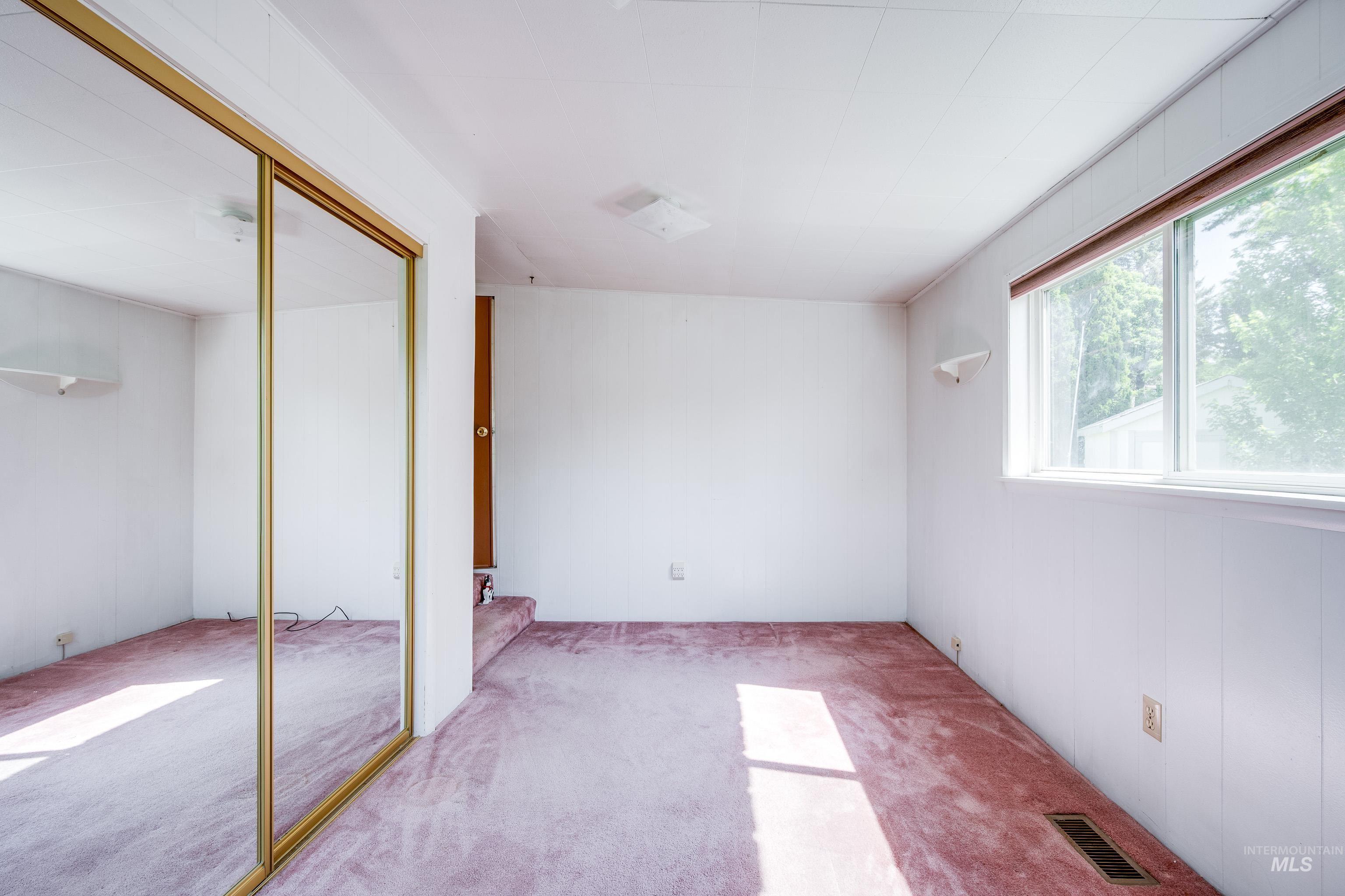 Unfurnished bedroom featuring carpet flooring and a closet