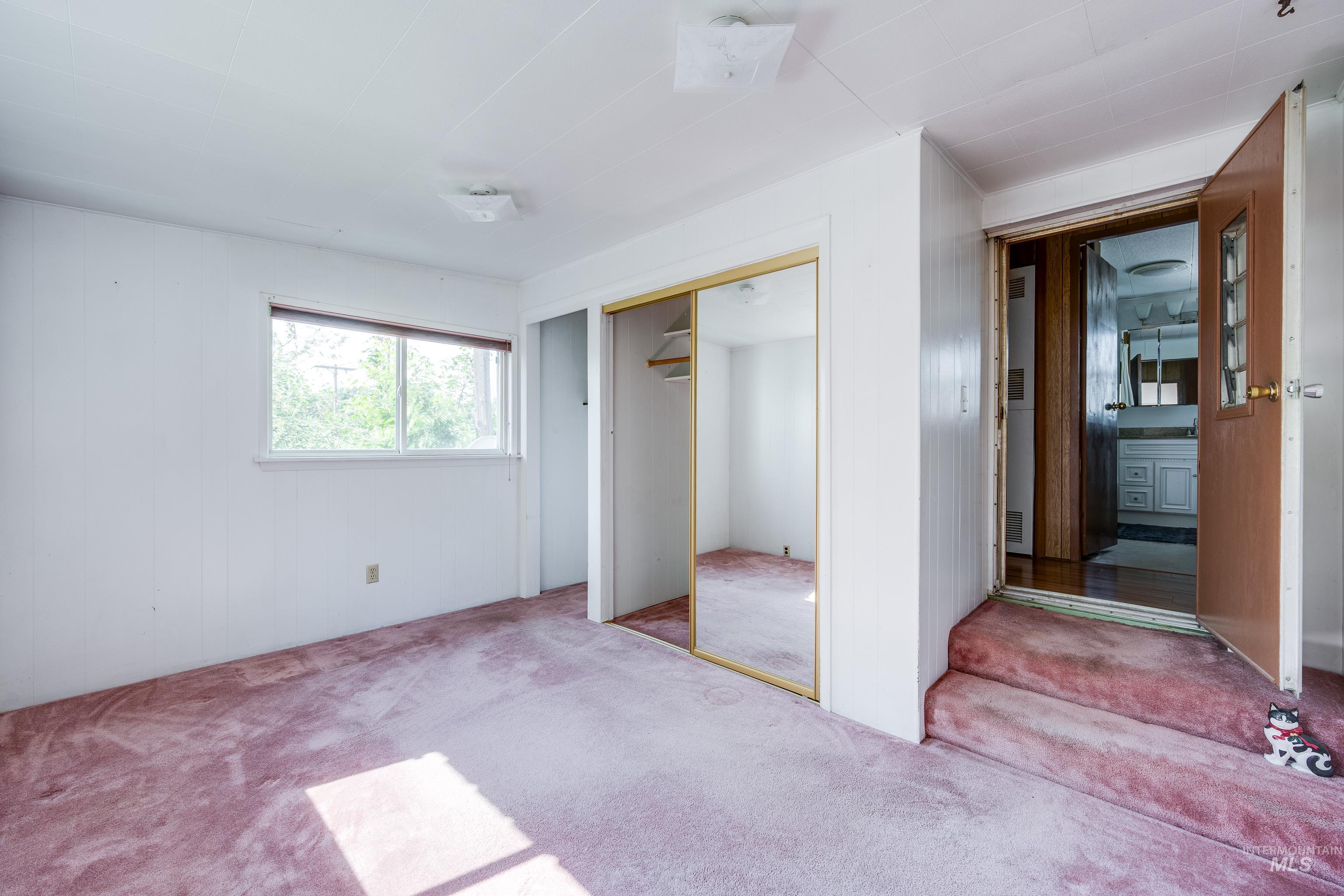 Unfurnished bedroom with carpet flooring and a closet