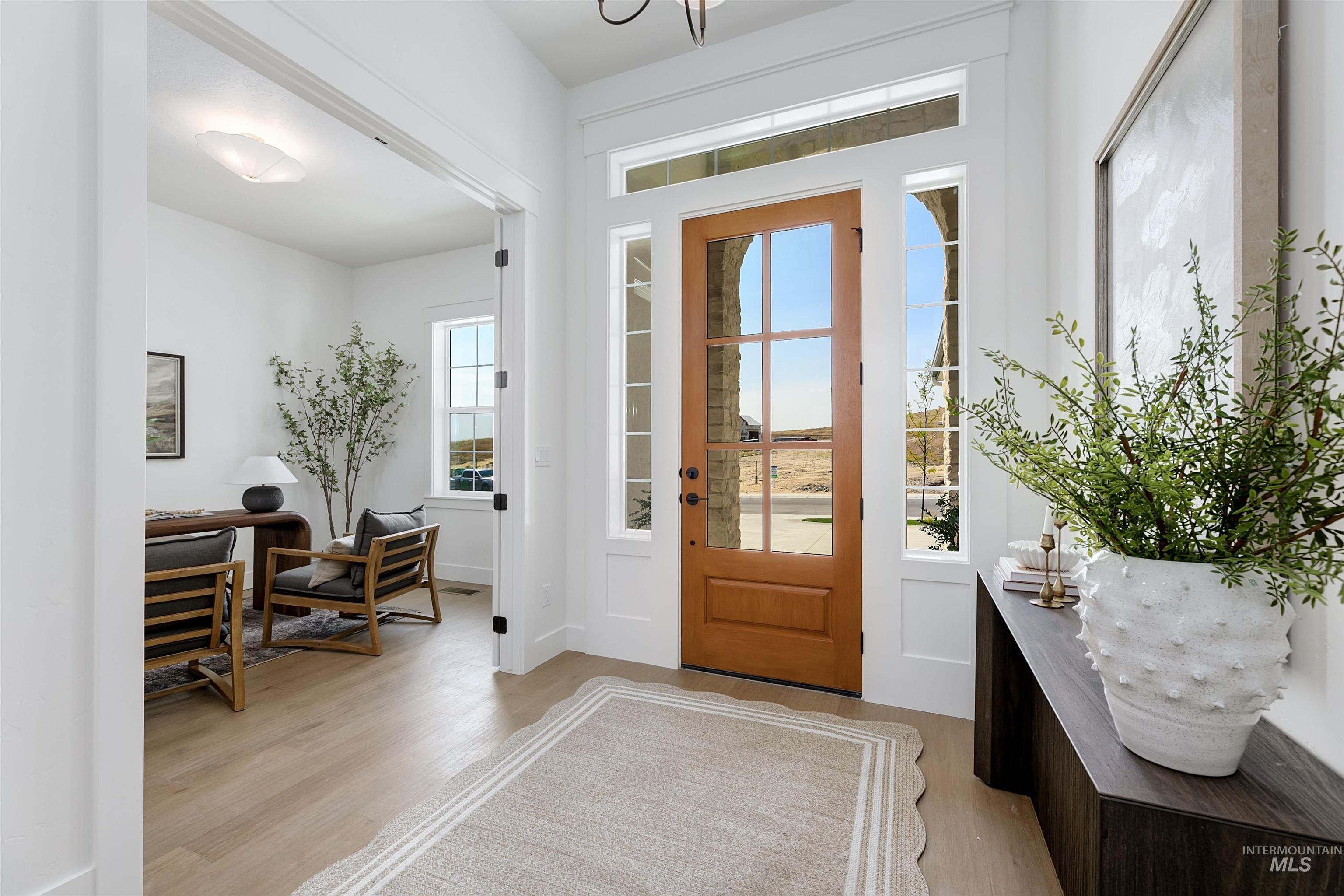 Entrance foyer with light wood-style floors