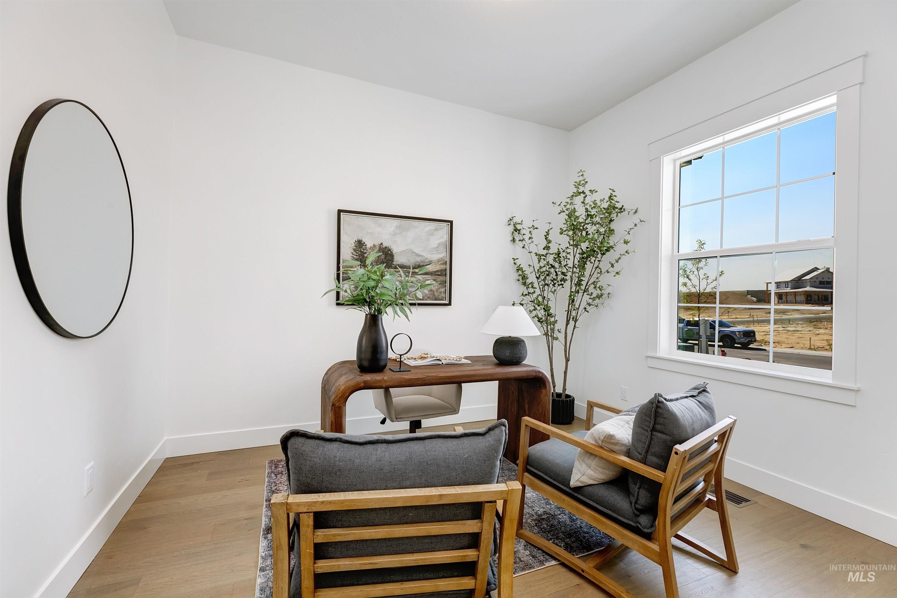 Office with light wood finished floors and baseboards