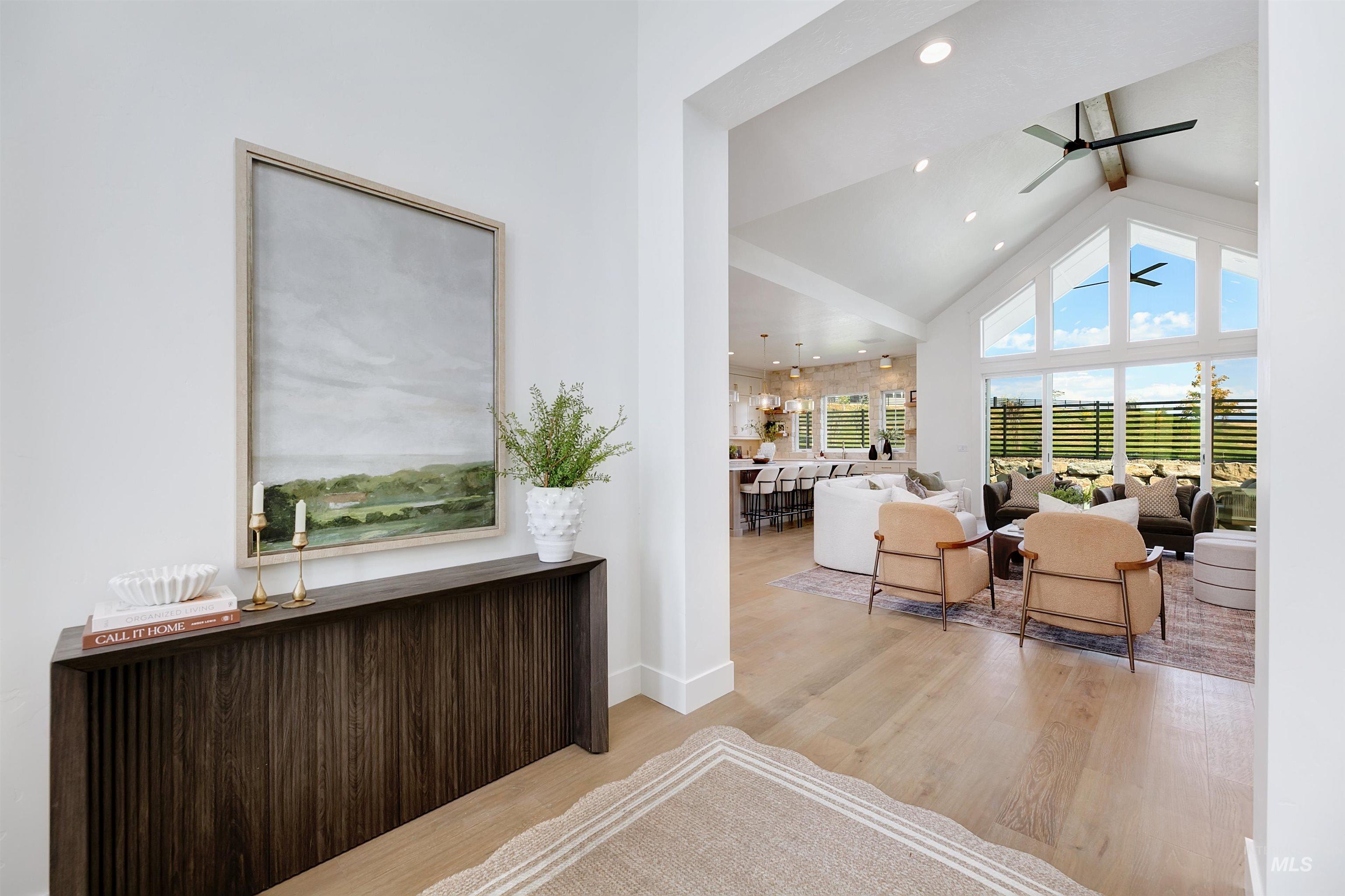 Interior space with high vaulted ceiling, light wood-type flooring, recessed lighting, and a ceiling fan