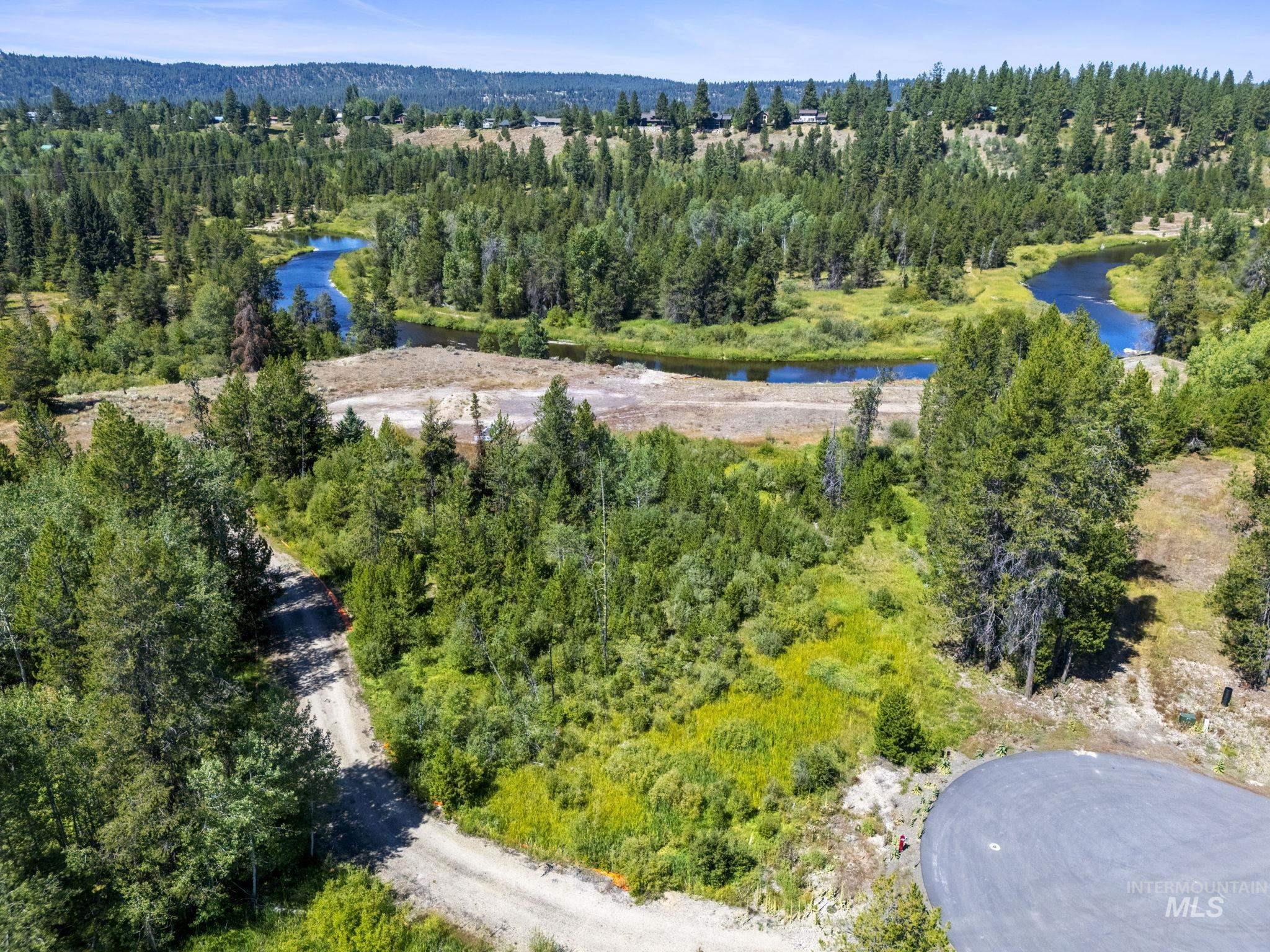 Drone / aerial view of a large body of water and a forest