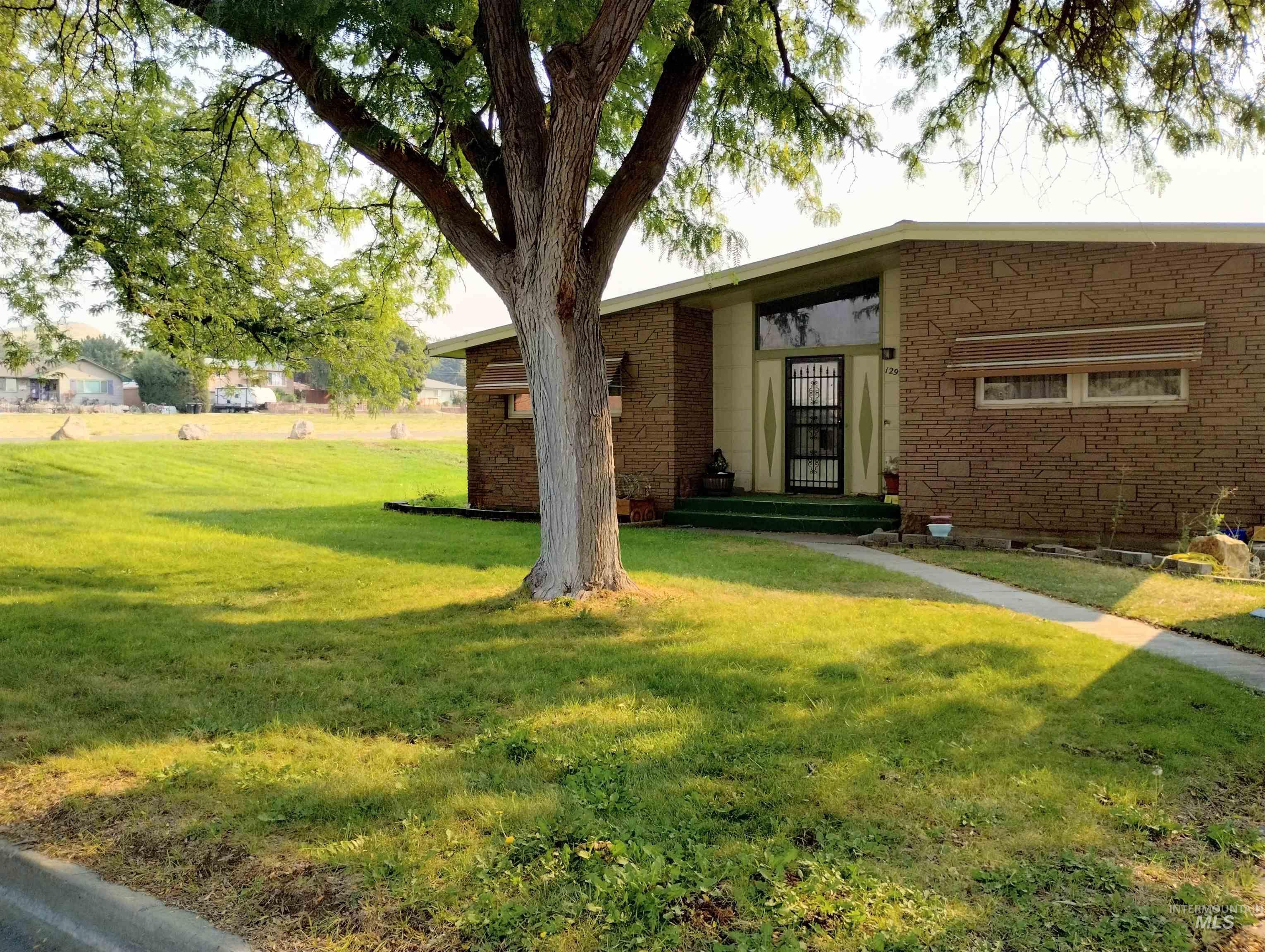 Entrance to property with a lawn
