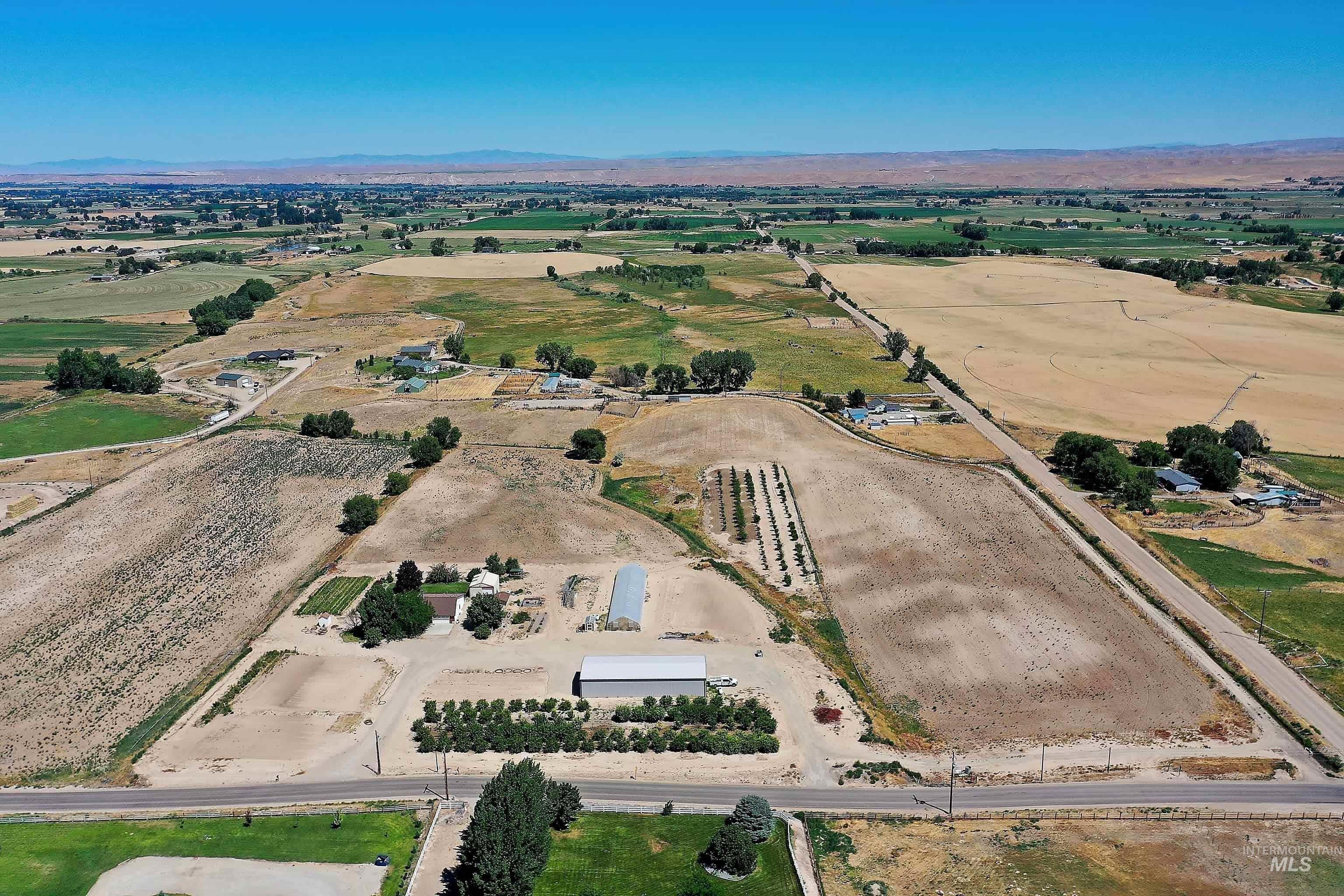 Aerial overview of property's location featuring rural landscape and a mountain backdrop