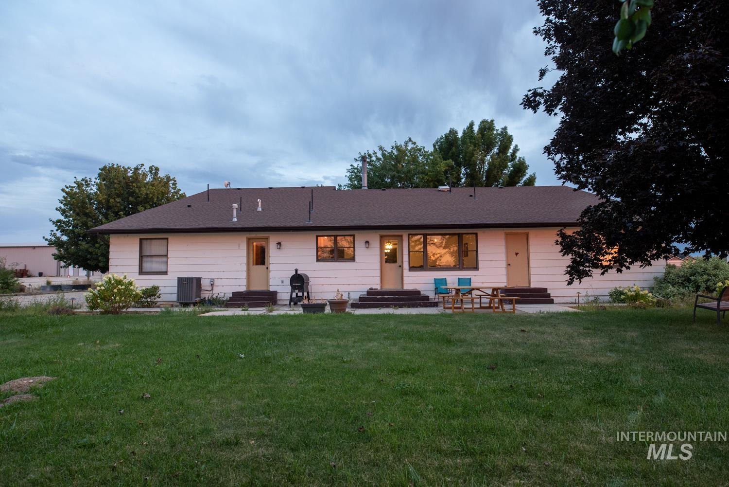 Back of property with a yard, entry steps, and a patio area