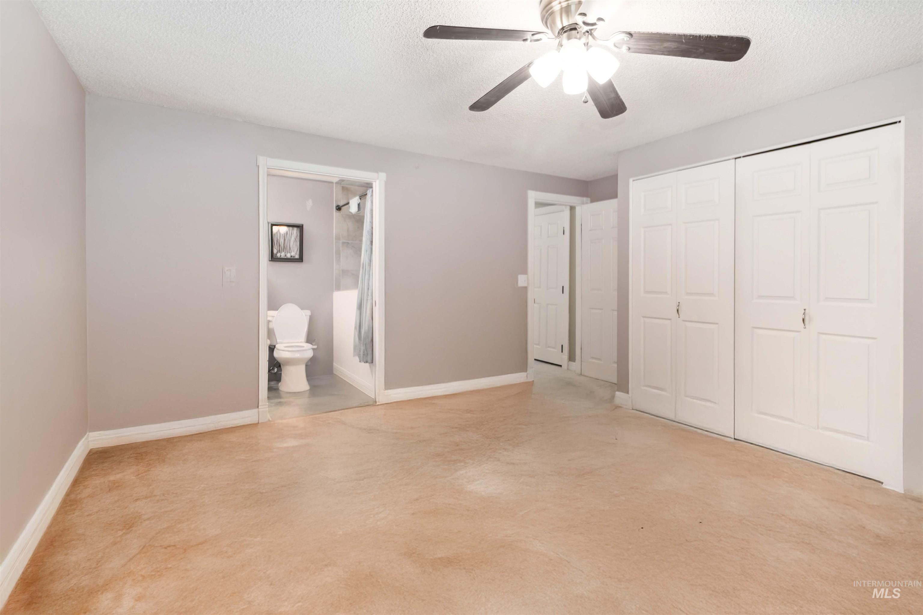 Digitally Unfurnished  master bedroom with double closets.