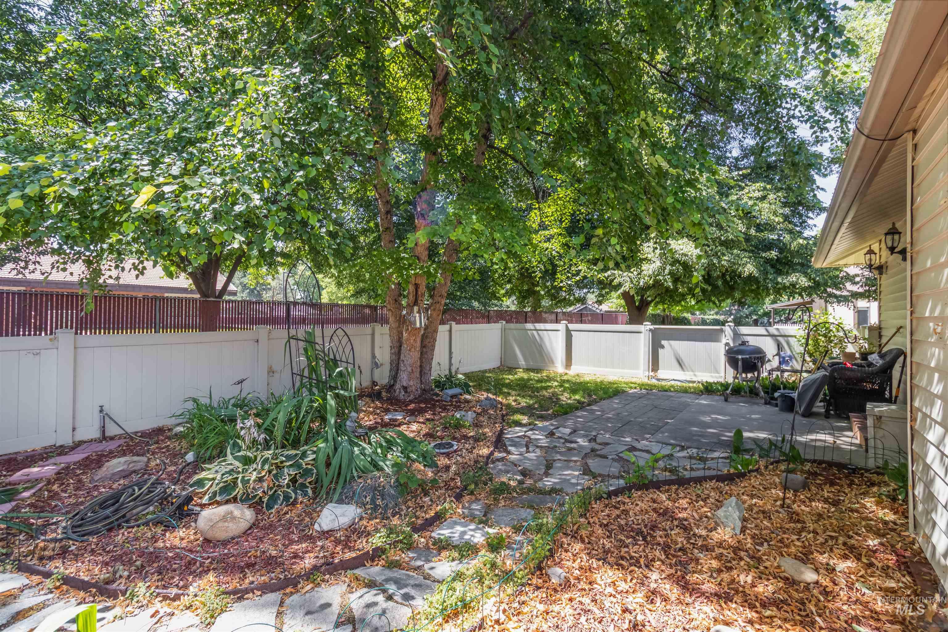 Fenced backyard with a patio