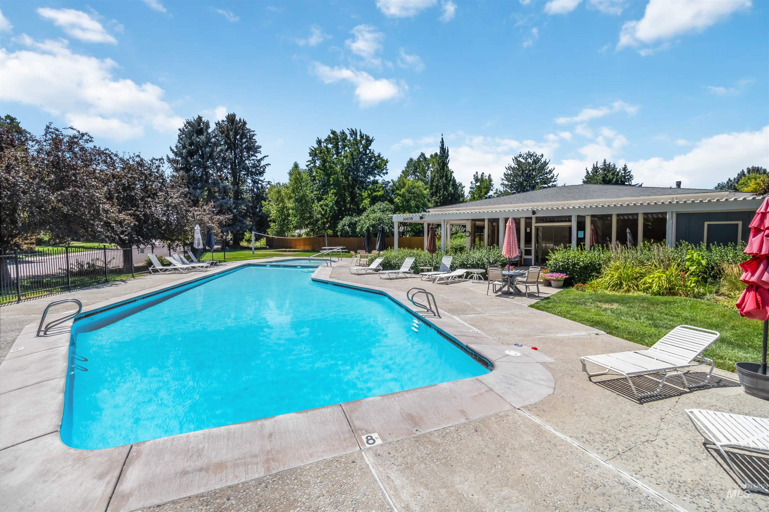 Community pool featuring a patio area and clubhouse.