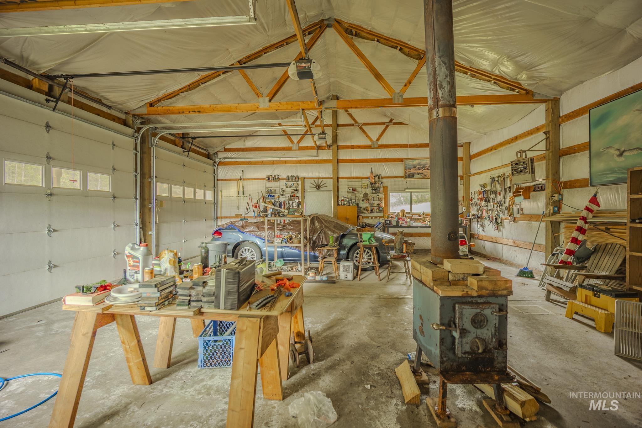Garage featuring metal wall and a garage door opener