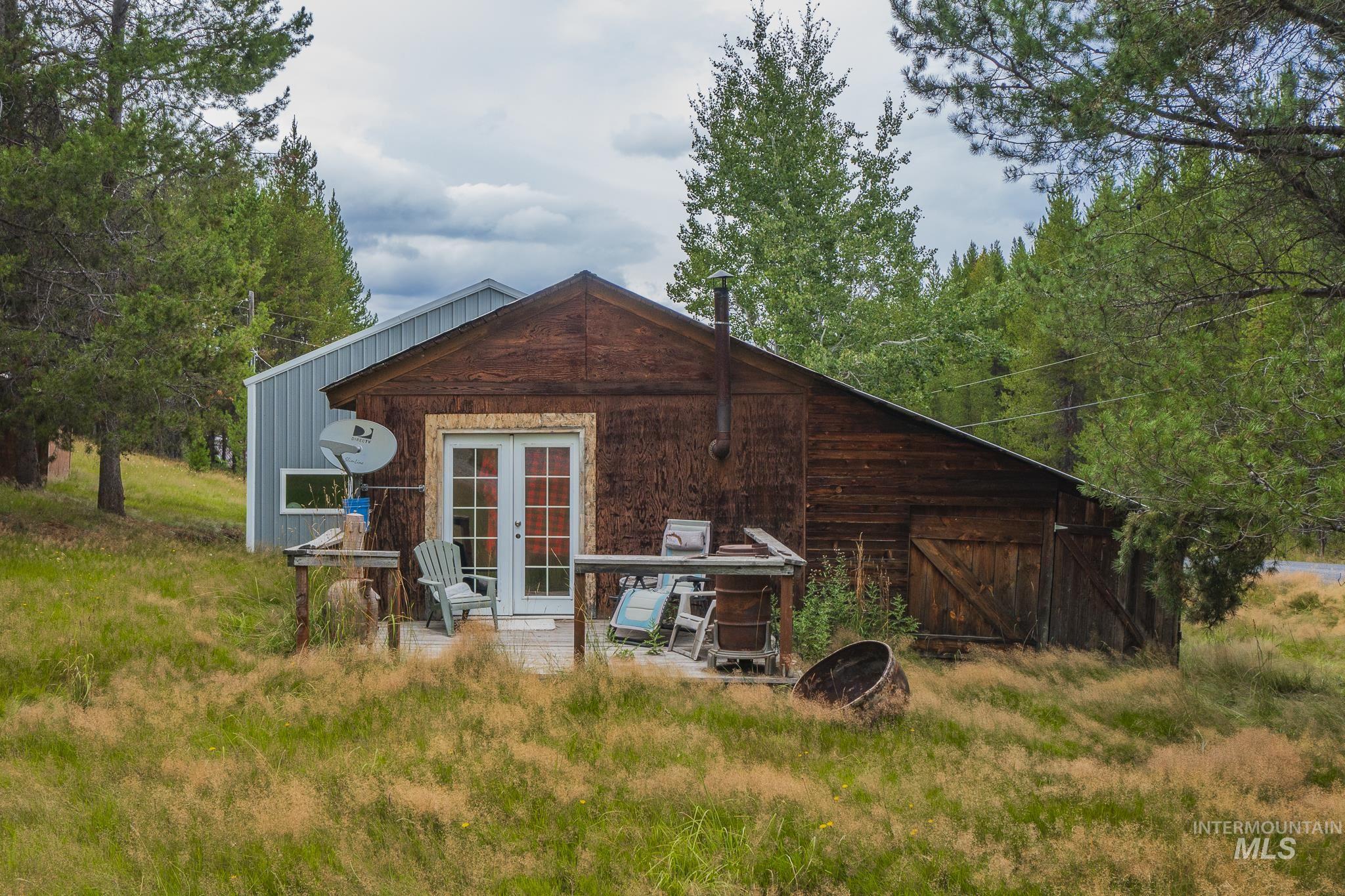Rear view of property with french doors, a patio area, and an outdoor structure