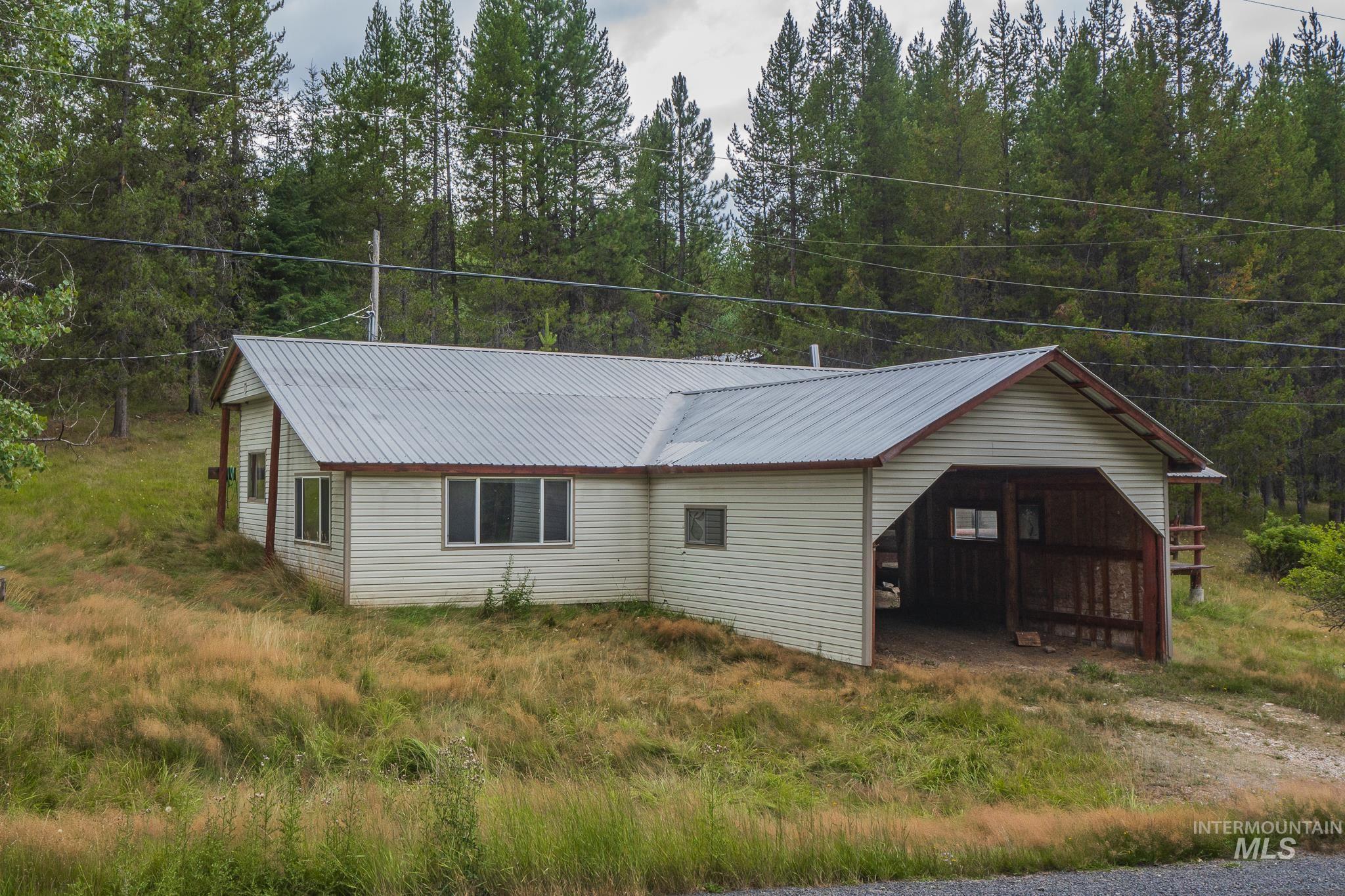 View of property exterior with a metal roof