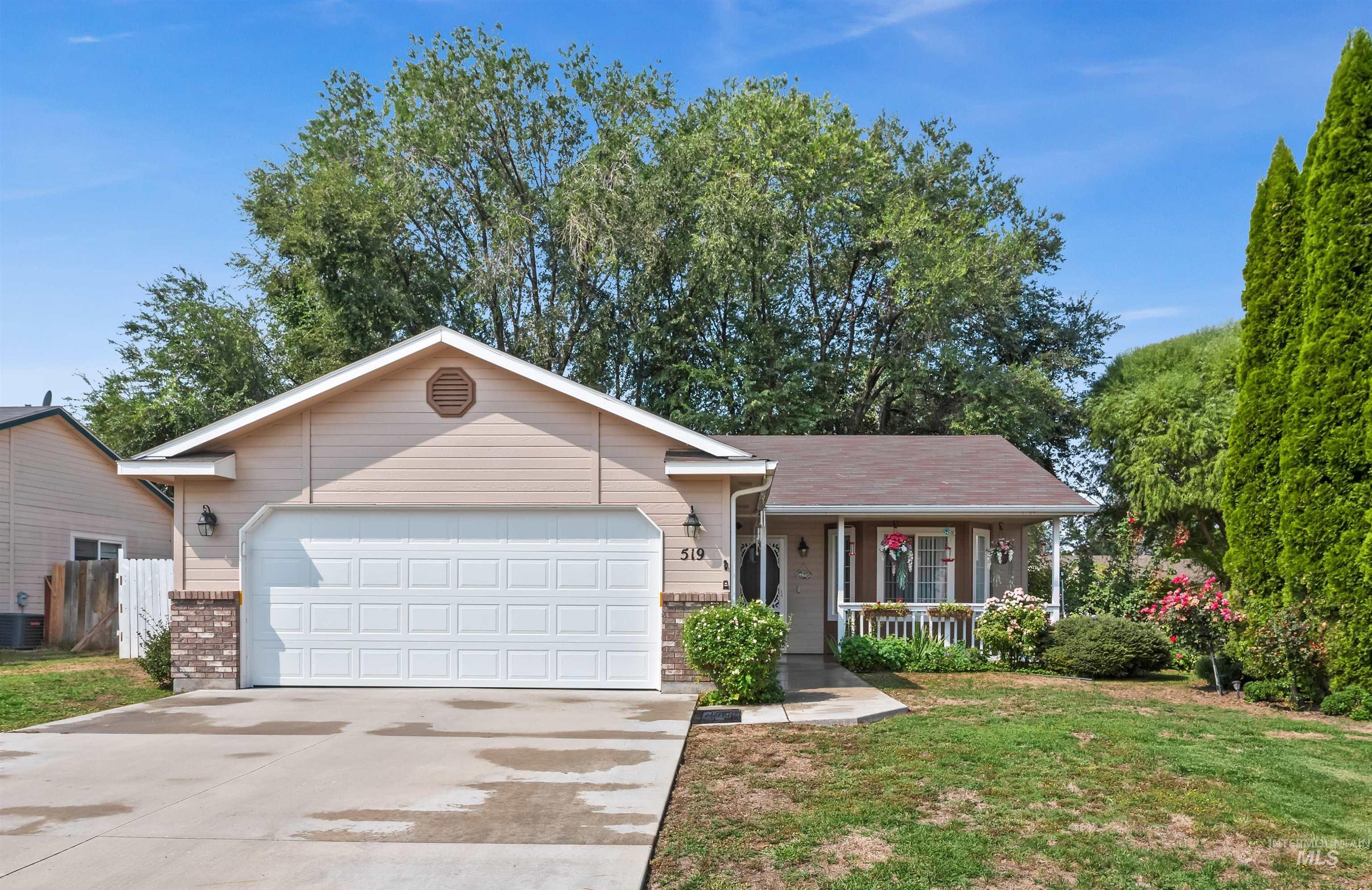 Single story home featuring a porch, concrete driveway, brick siding, and an attached garage