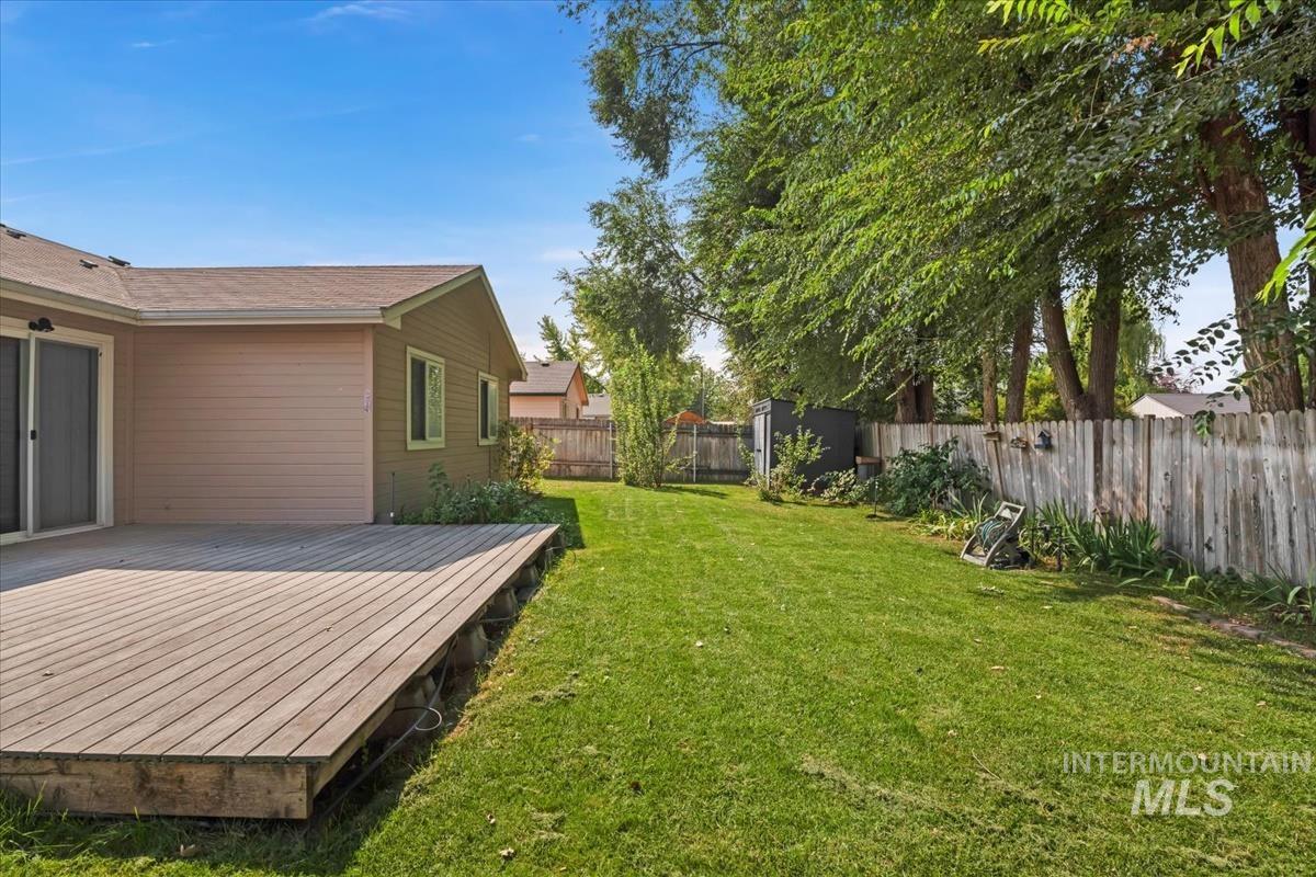Fenced backyard with a wooden deck