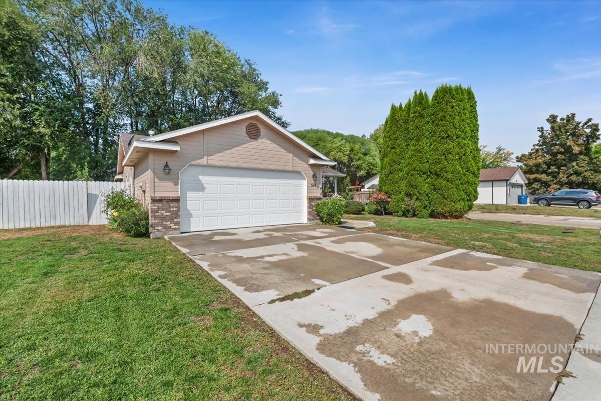 View of front of property with concrete driveway and brick siding