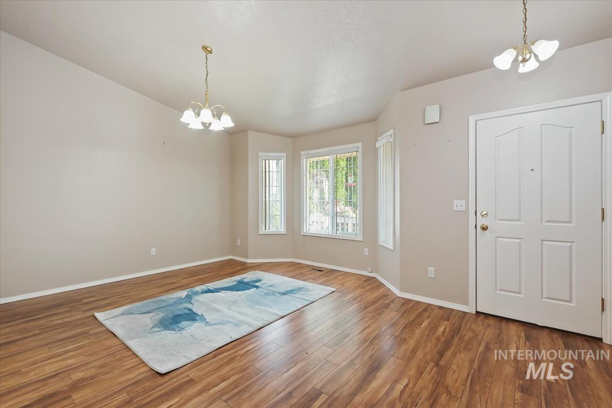 Entryway with a chandelier and wood finished floors