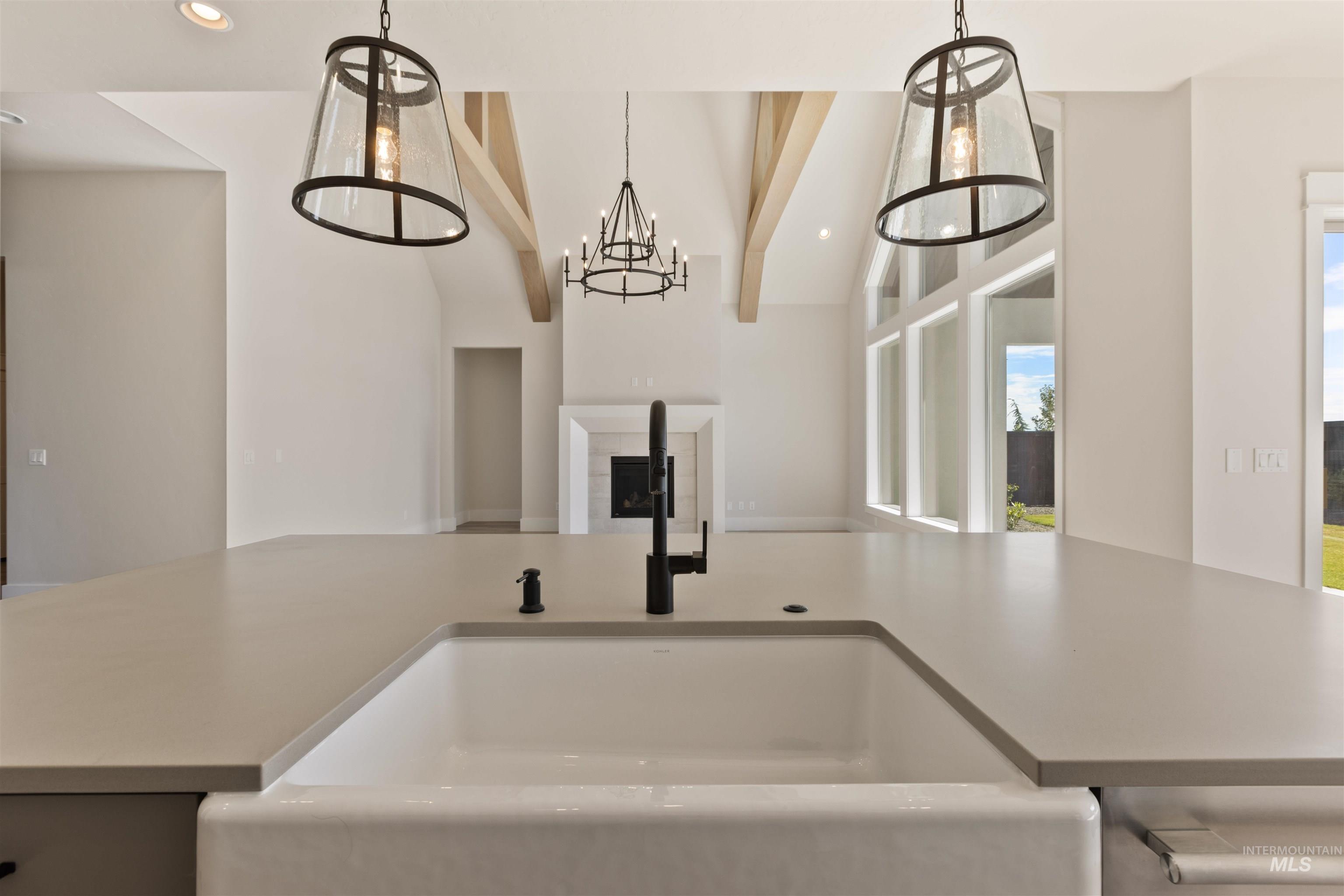 Kitchen featuring pendant lighting, recessed lighting, vaulted ceiling, open floor plan, and a chandelier