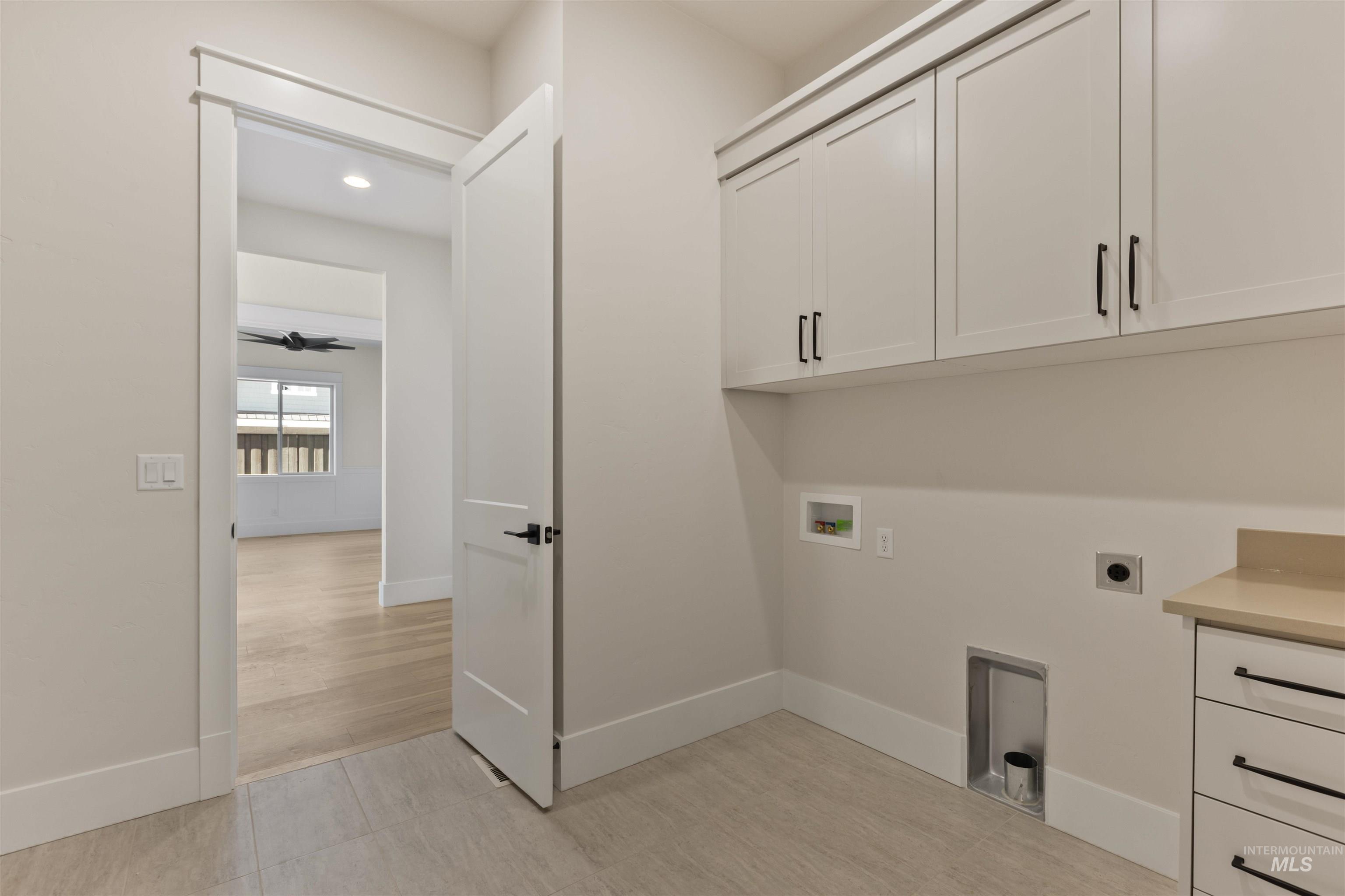Laundry room with electric dryer hookup, cabinet space, hookup for a washing machine, and recessed lighting