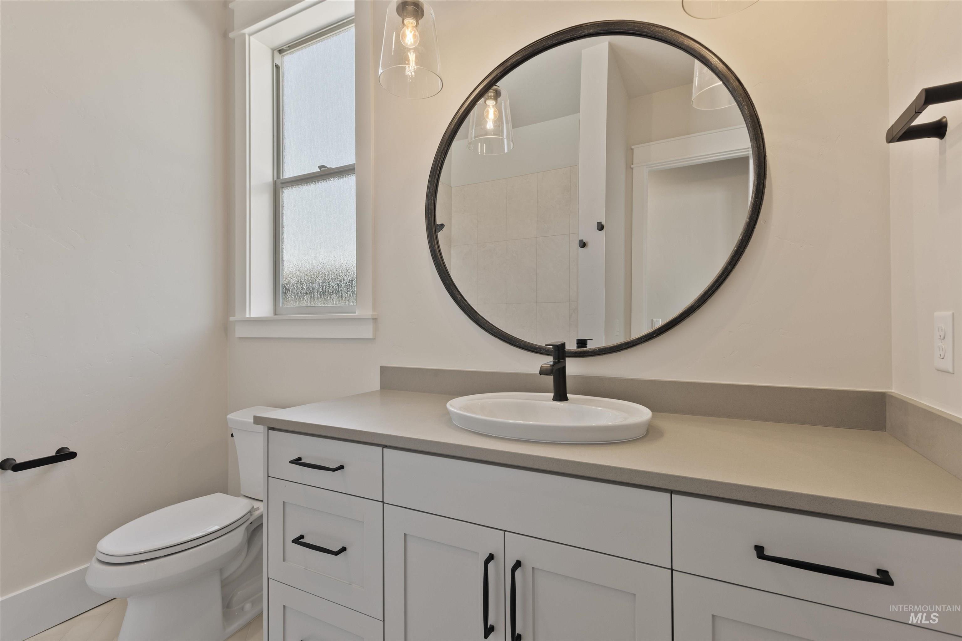 Full bath featuring vanity and toilet