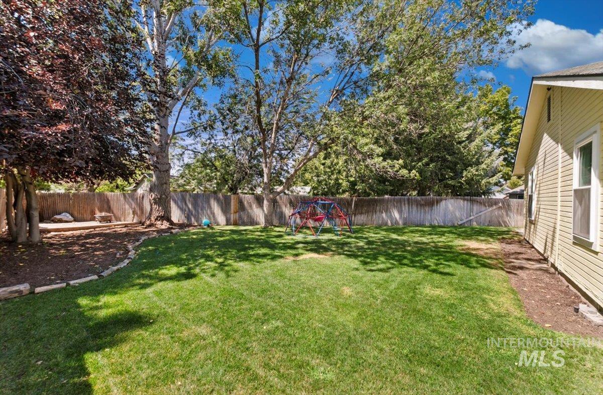 Fenced backyard with a playground