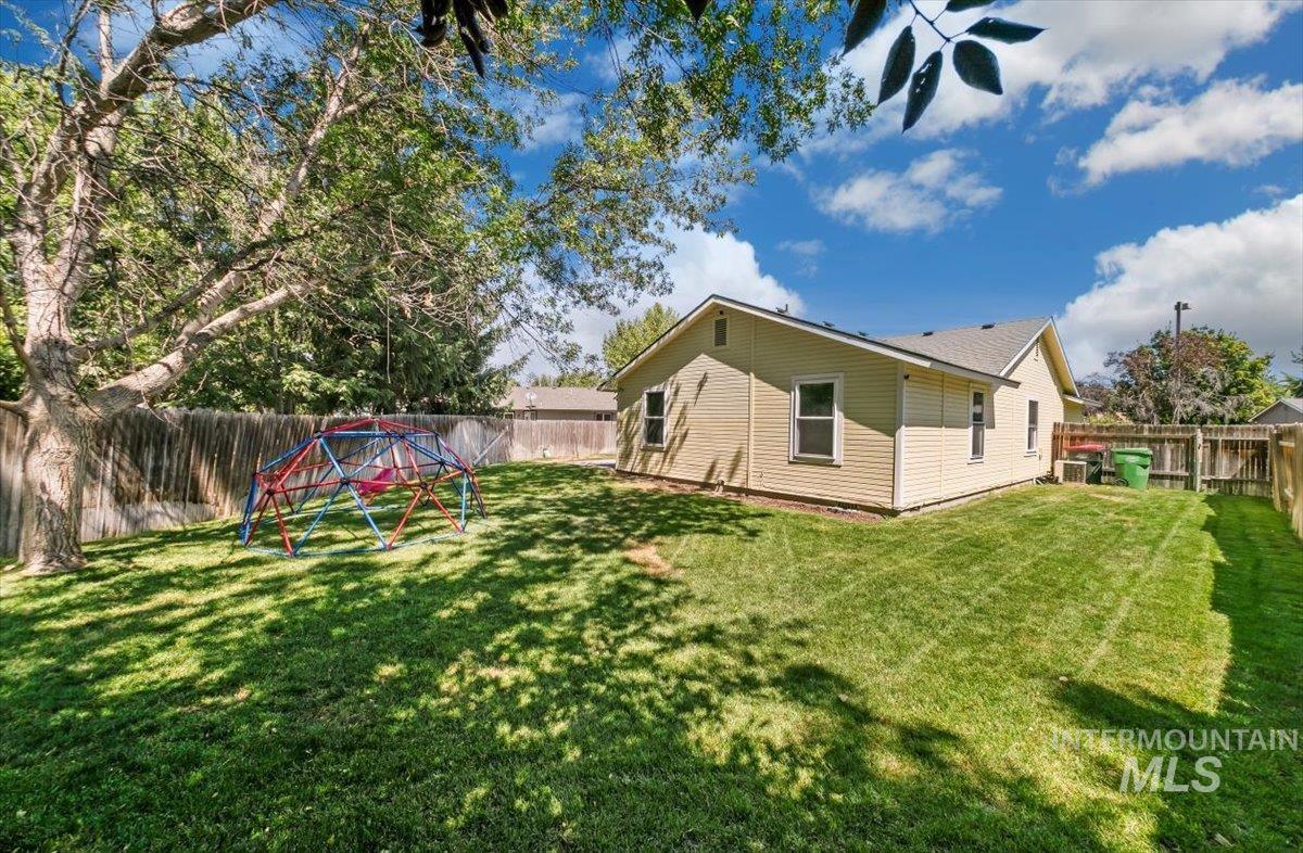 Rear view of house featuring a fenced backyard