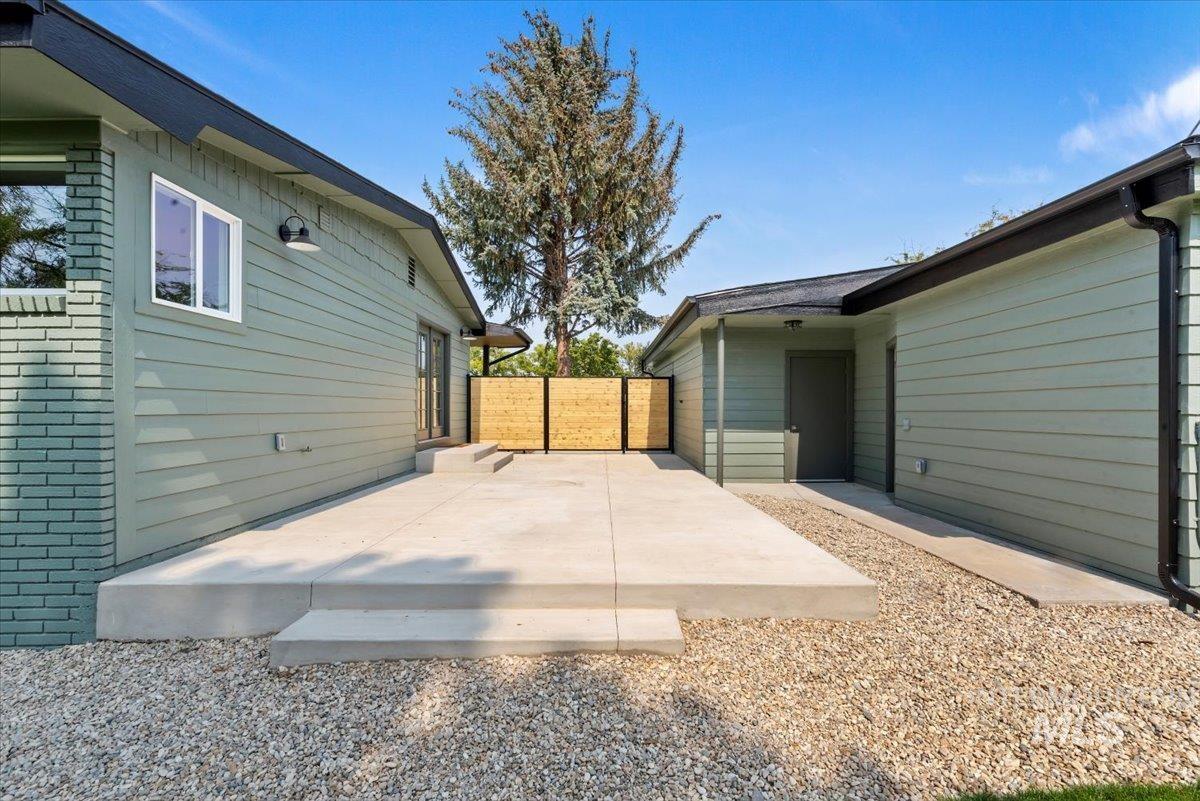 View of property exterior featuring brick siding and a patio area