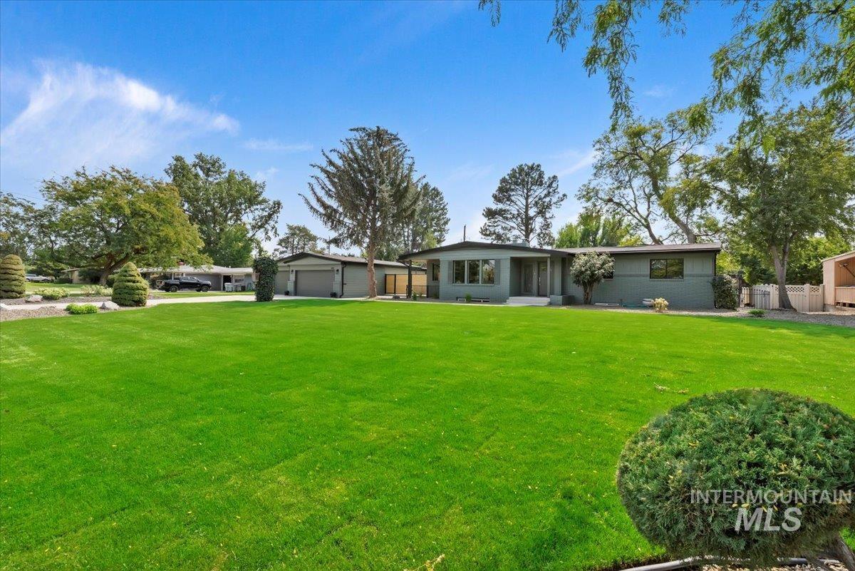 Back of house featuring a garage and driveway
